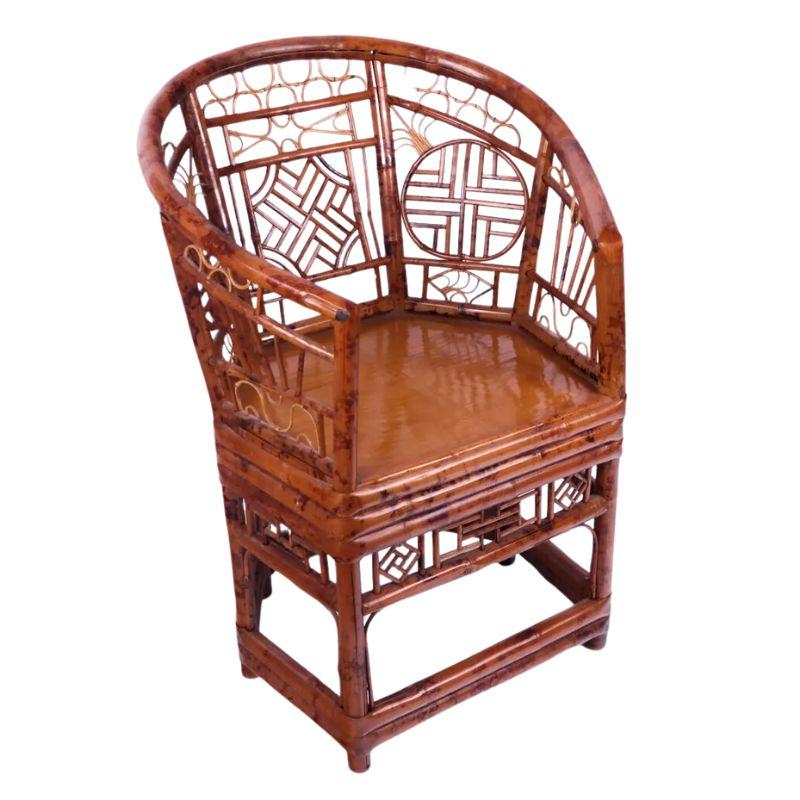 A vintage rattan Brighton Pavilion chair with a loose cushion.  The graceful horseshoe shape to the chair and intricate rattan design makes this chair quite special.  A variety of open fretwork design circles the back of the chair.  
