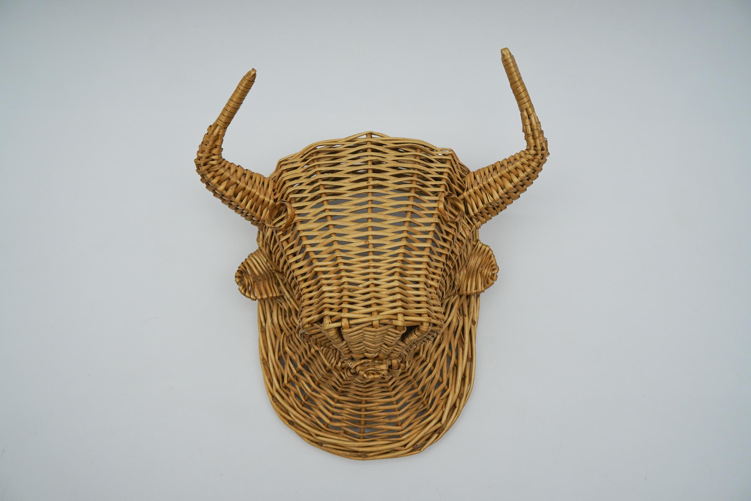 Very rare rattan bull head, wicker wall decoration dates to the 1960s-1970s

The proportions are perfect, very decorative.

We still have a dark lacquered bull head in rattan which is woven very similarly.
