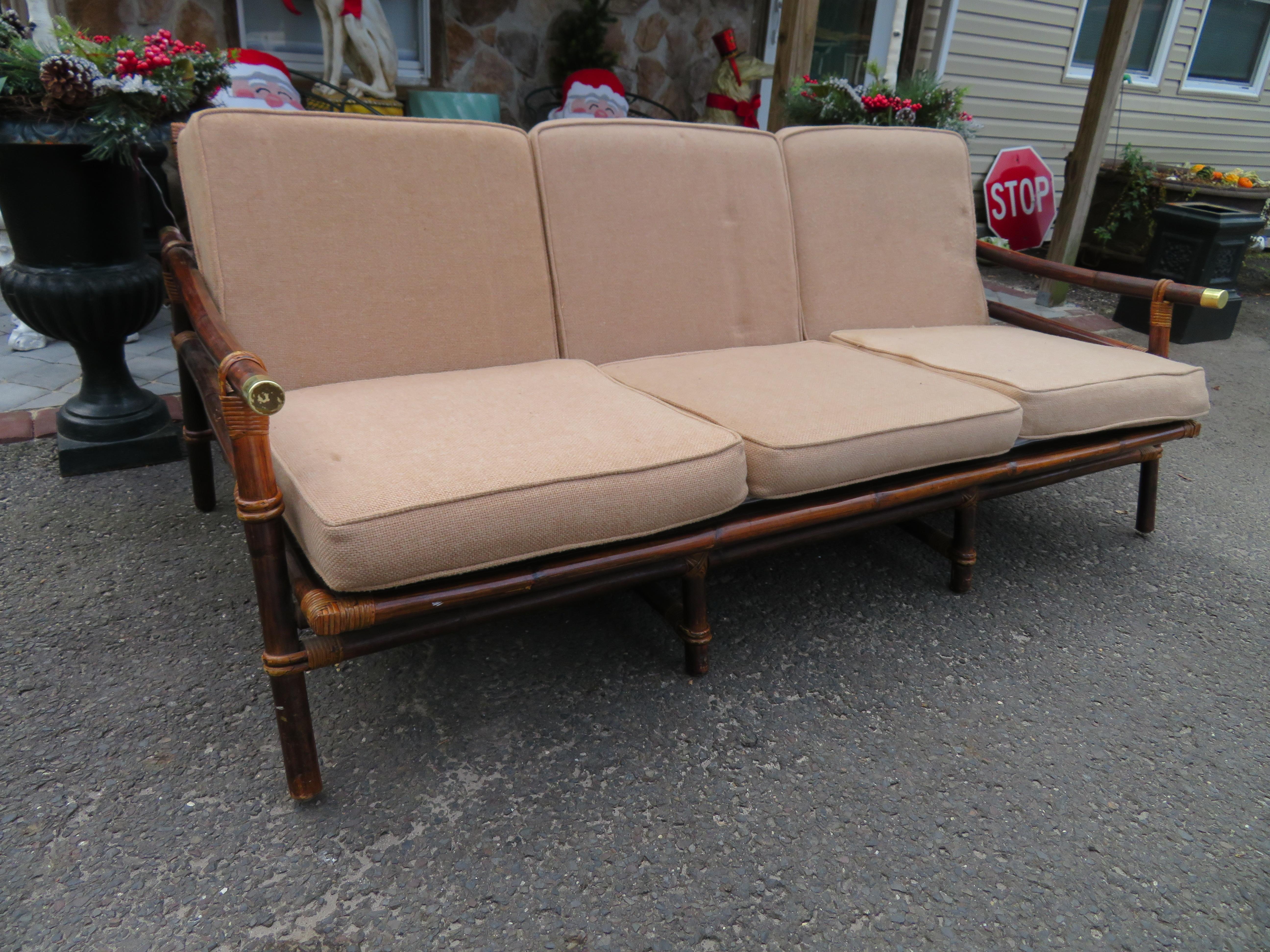 Wonderful vintage rattan Campaign style Ficks reed Far Horizon Collection sofa designed by John Wisner. We love the warm light brown bamboo color on this piece matching other pieces from this collection that we have. The cushions are still soft and
