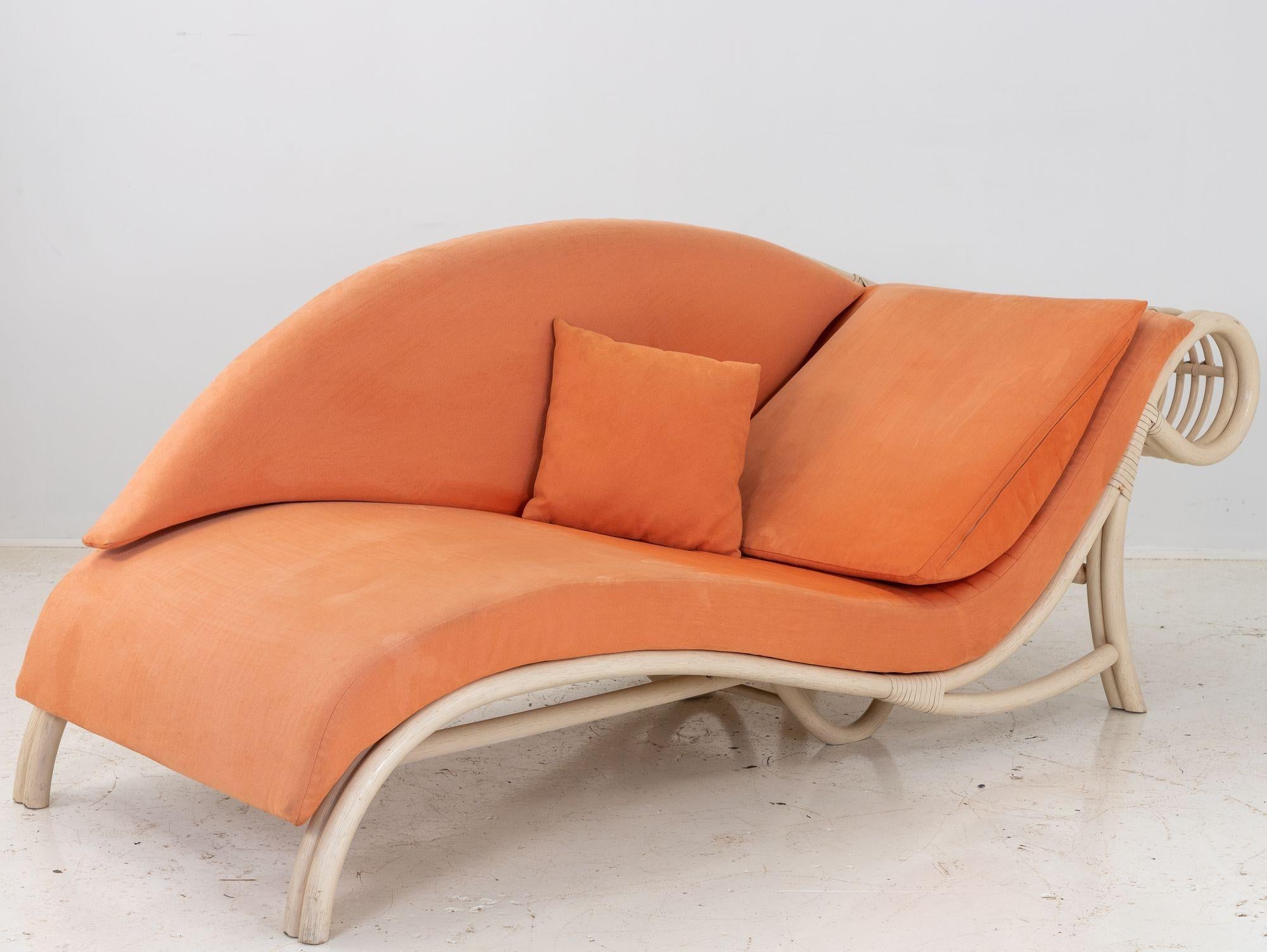 A modern rattan canapé sofa from France in the 1980s. Painted white rattan has a lovely sinuous form with original coral velvet upholstery. Perfect for upholstery. Wear consistent with age and use. Measure: Seat height 11