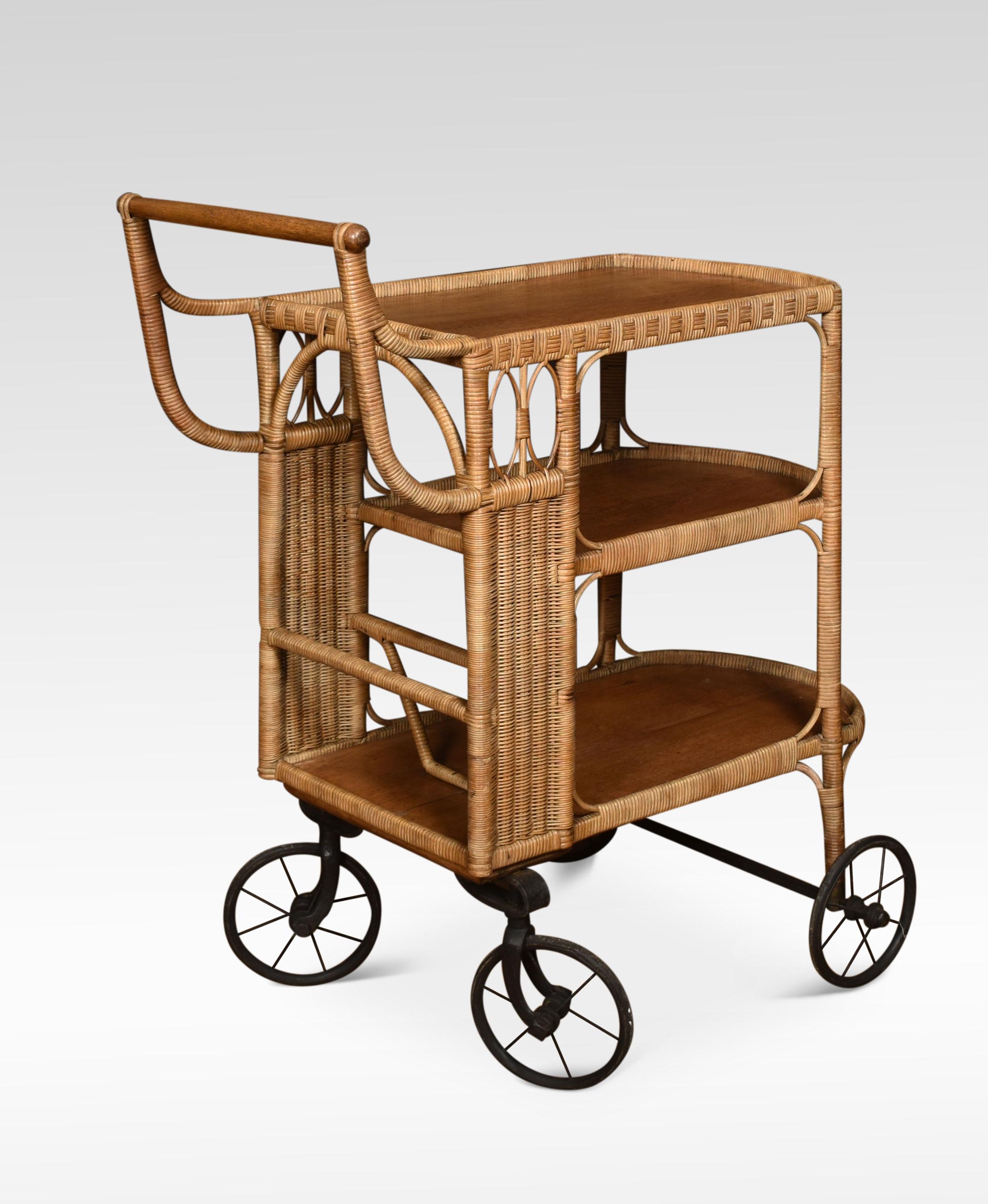 Rattan cane and oak drinks cart or drinks trolley. Featuring a three-tiered body with decorative accents – the top tier with a gallery and handle over two further tiers with inset oak shelves all raised up on four spoked wheels.
Dimensions:
Height