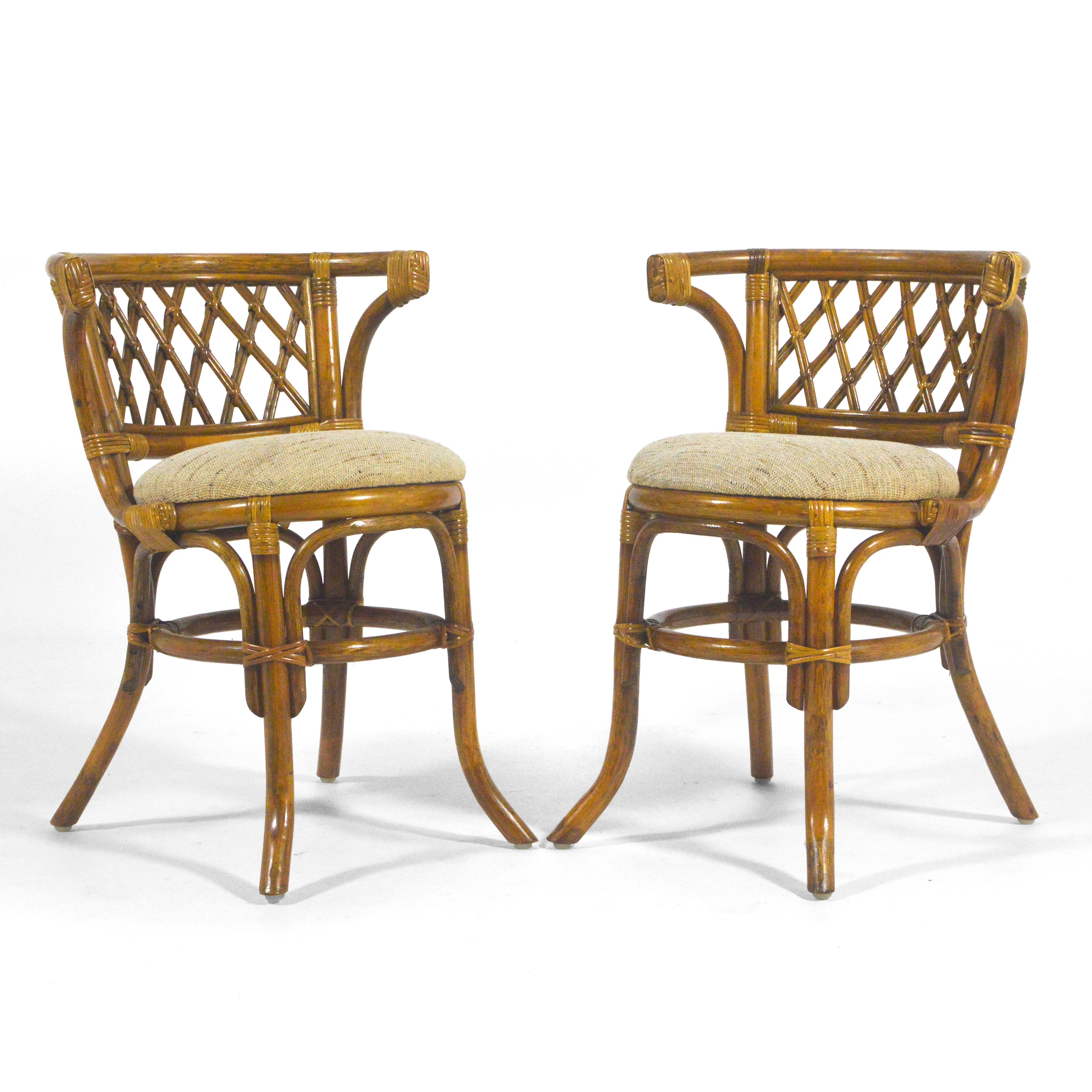 This lovely little rattan and cane set made by P.T. Chain in the late 1970s includes a small table with an oval glass top and two chairs that fit under the table, creating a compact footprint. Perfect as a breakfast table or game table, the elegant