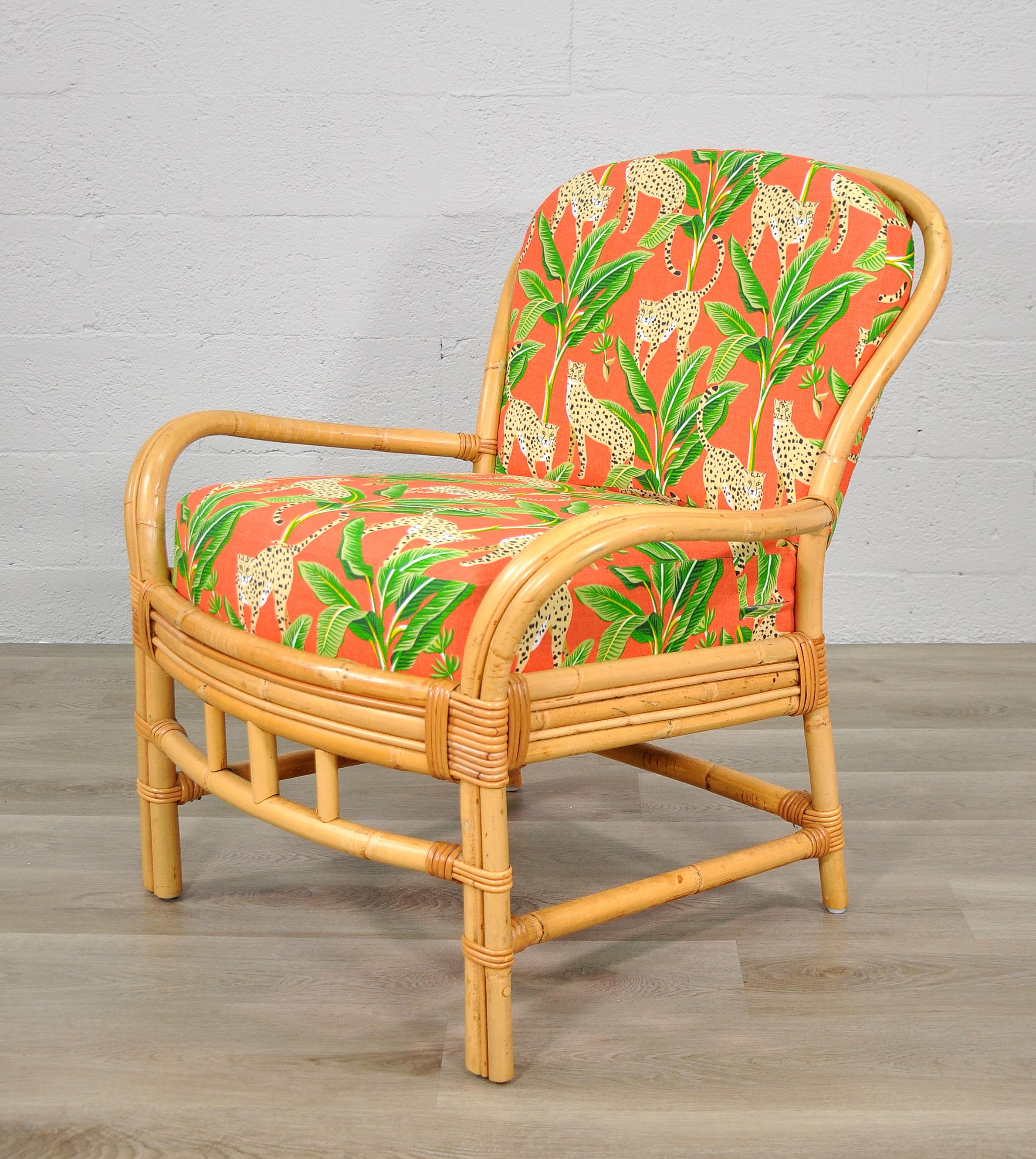 New cushions with emerald green and salmon orange indoor / outdoor fabric on this vintage rattan armchair. Made in San Francisco, California by Palecek. The new removable cushions have been covered in a performance fabric with tropical themed