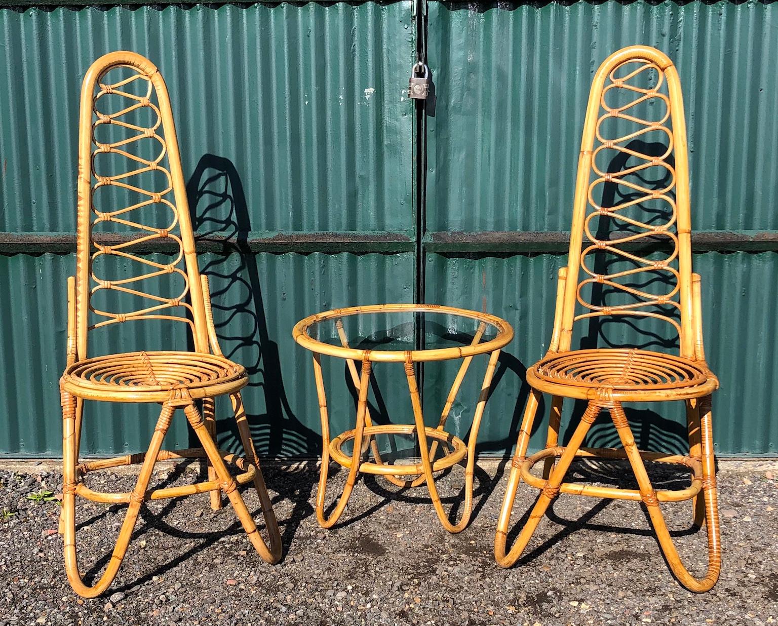 Rare Mid Century table and chairs set by Dirk Van Sliedrecht for Rohe Noordwolde, Netherlands, 1950s

Stunning rare set by Dirk Van Sliedrecht for Rohe Noordwolde.
Set comprises of 2 x high back rattan chairs plus matching round 2-tier glass table,