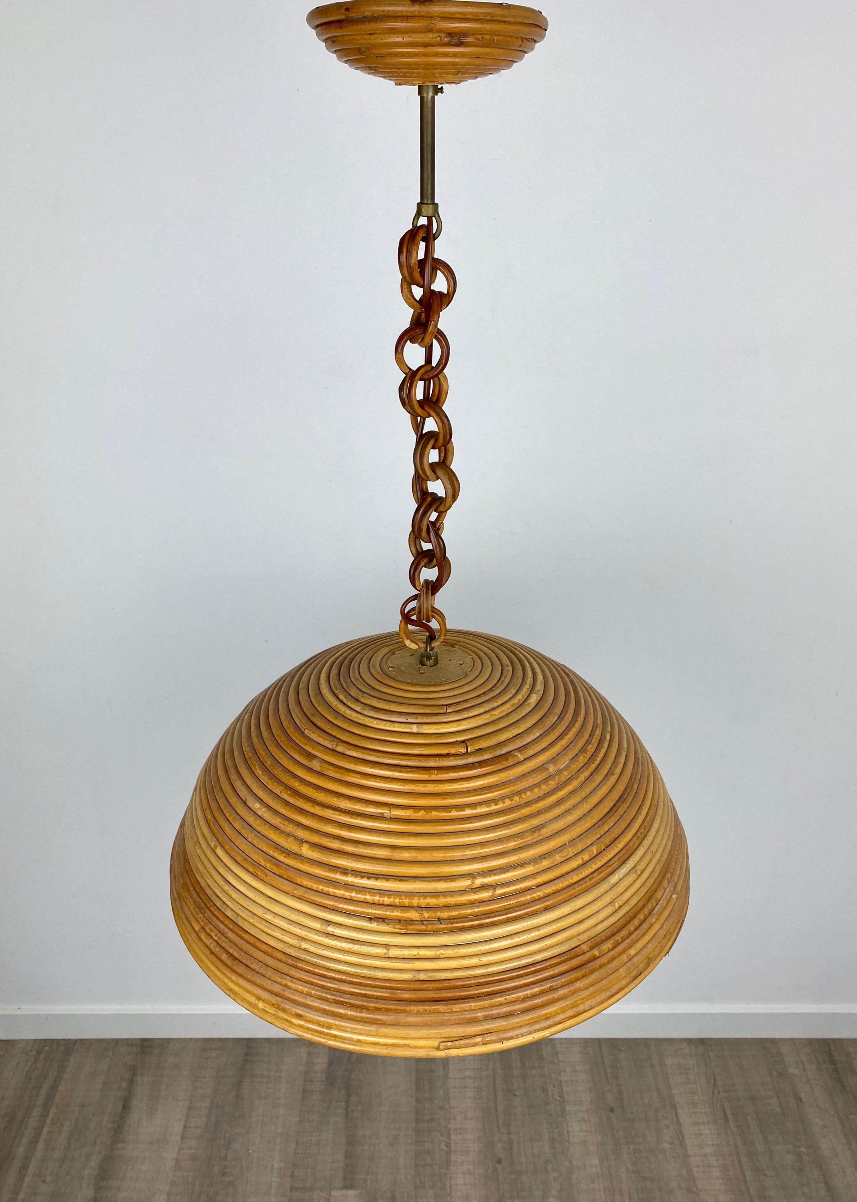 Beautiful midcentury pendant lamp handcrafted in Italy made of rattan. This lamp is a striking appearance in any room. It is a perfect representation of the 1960s period because of its design, quality and functionality.

Dimensions: 
Diameter 46 cm