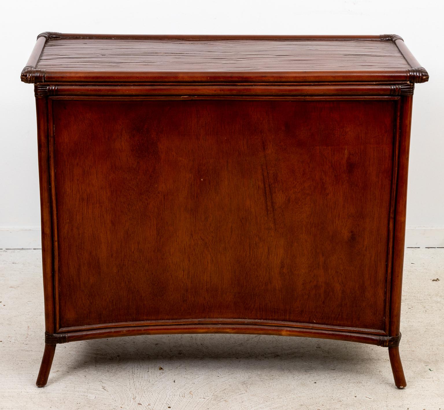 Circa 2010 Rattan chest with sunburst detail on four drawers. Please note of wear consistent with age. Key not included.