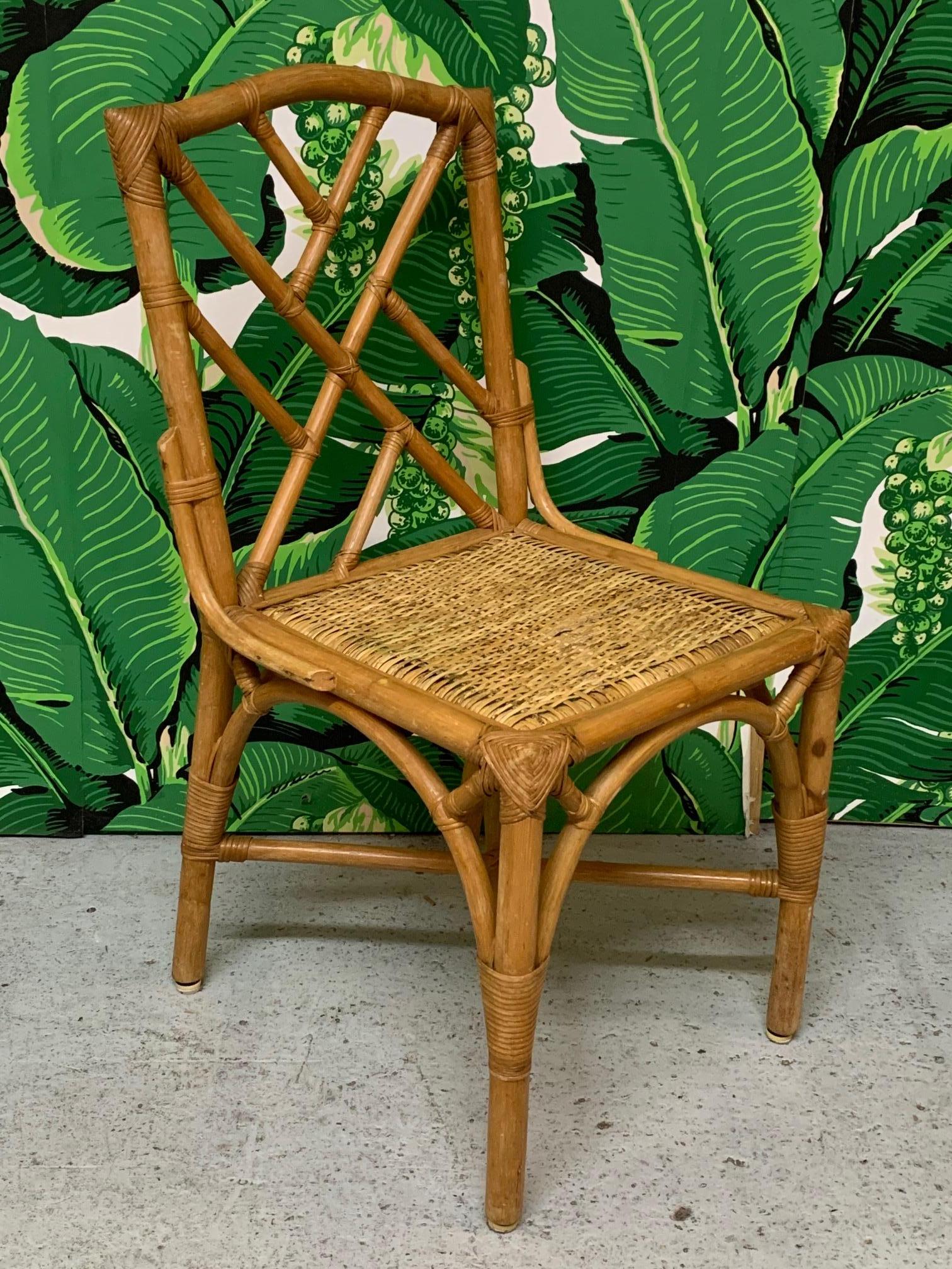 Set of six rattan dining chairs in Asian chinoiserie style. Iconic Chinese Chippendale pattern in back, and woven rattan seats. Good vintage condition with minor imperfections consistent with age.