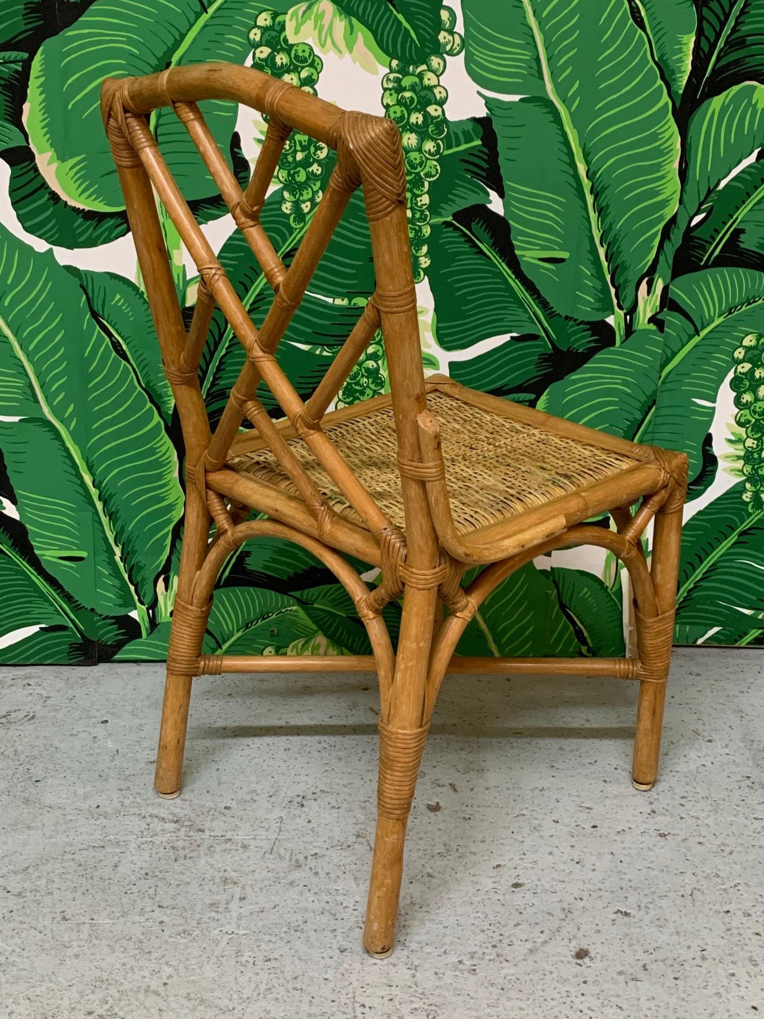 Set of six rattan dining chairs in Asian chinoiserie style. Iconic Chinese chippendale pattern in back, and woven rattan seats. Good vintage condition with minor imperfections consistent with age. 
**Please note: We offer shipping direct from our