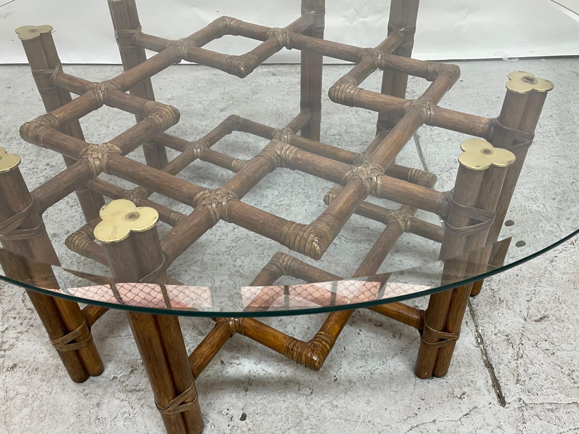 Vintage rattan coffee/cocktail table by McGuire features a modern take on chinoiserie style fretwork and brass detailing. 42
