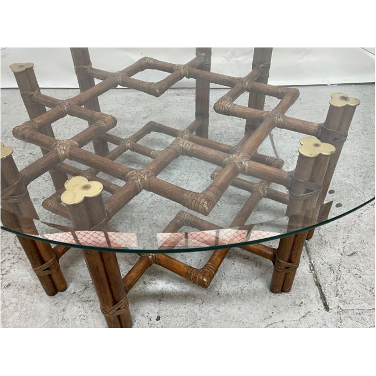 Vintage rattan coffee/cocktail table by McGuire features a modern take on chinoiserie style fretwork and brass detailing. 42