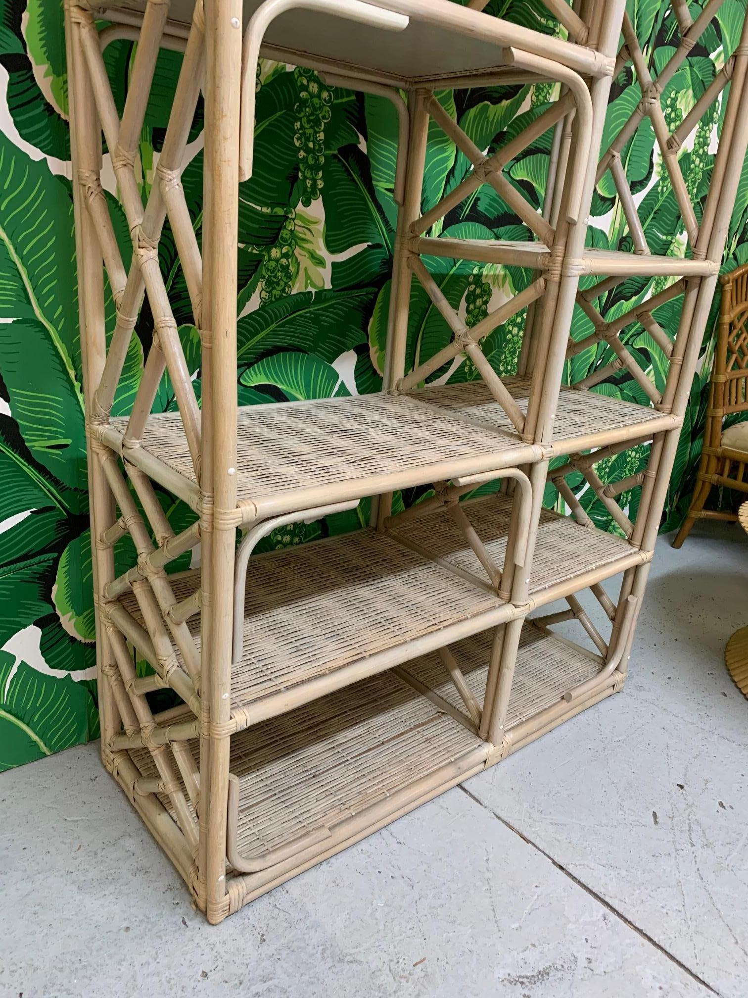Large rattan étagère features chinoiserie styling and woven wicker shelves. In the manner of Bielecky Brothers. Plenty of storage with tropical bamboo styling. Good condition with only minor imperfections consistent with age.