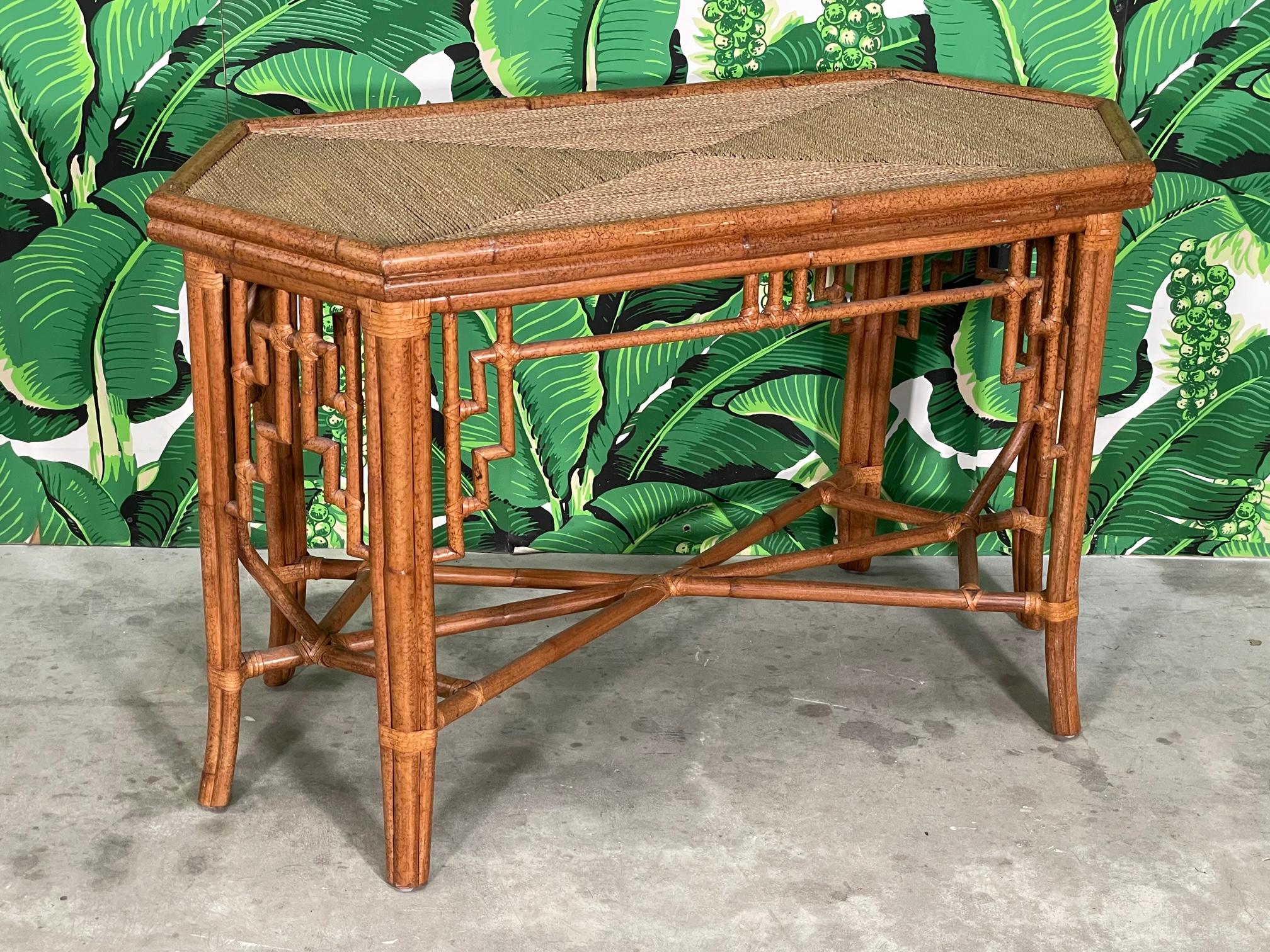 Rattan dining table base features Asian style fretwork, leather wrapped joints, and a top veneered in wicker rope. Can be used as a dining table base when a glass top is added, or as is as a console or hallway table. We have various glass tops