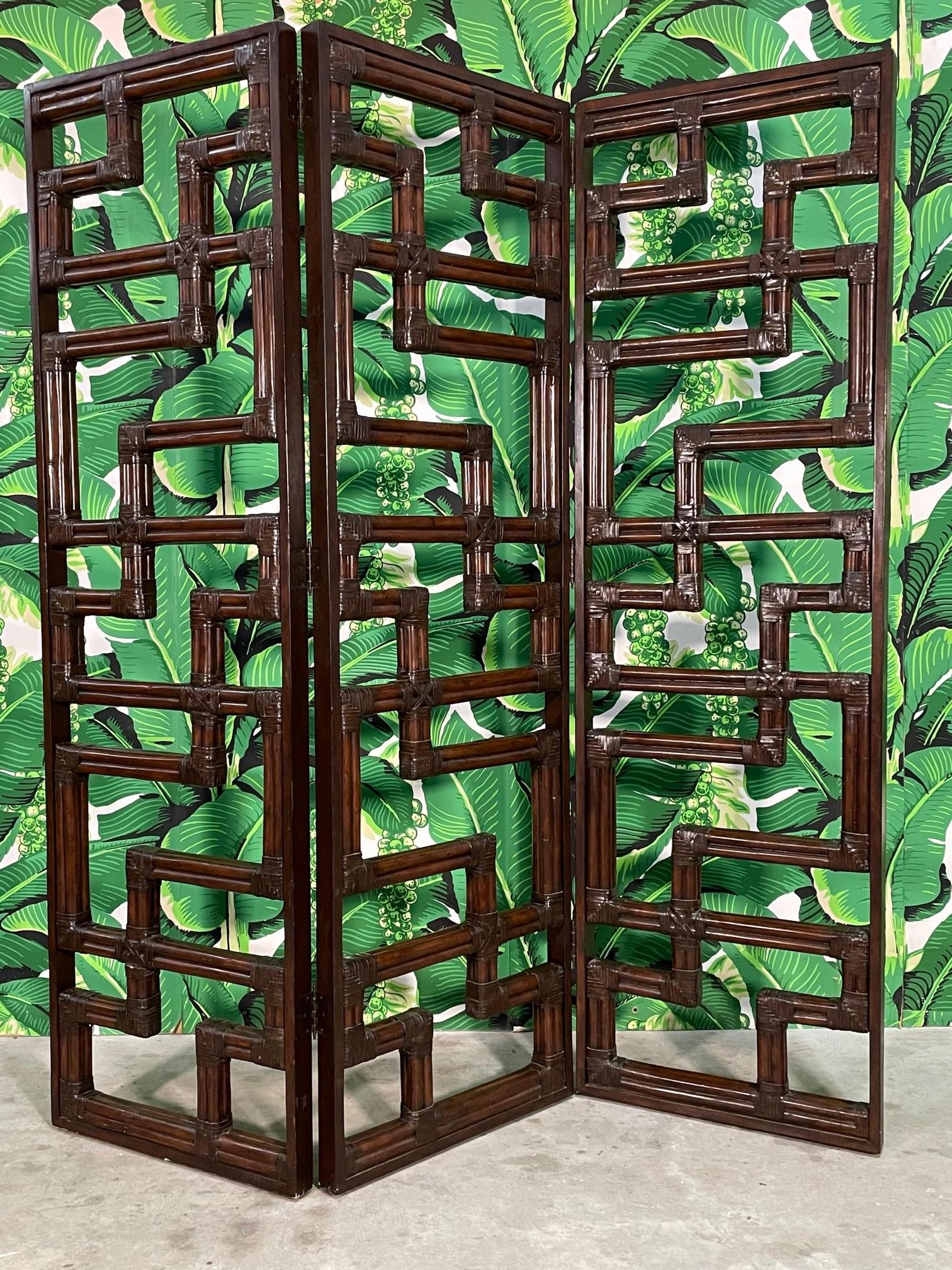 Rattan room divider screen features a heavy rattan geometric fretwork design and solid wood frame. Three panels open to a total of 64.5