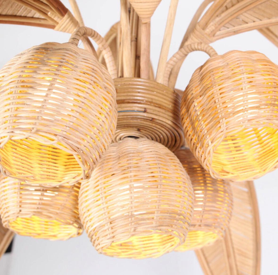 Large rattan « coconut tree/ palm tree » ceiling light with 5 lights in the coconuts and 10 adjustable palms that come off for the shipping. Very decorative, this chandelier is unique and will bring a sunny touch to your room. Very high quality of