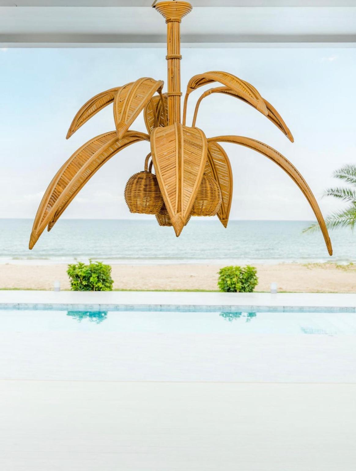 Large rattan « coconut tree/ palm tree » ceiling light with 5 lights in the coconuts and 10 adjustable palms that come off for the shipping. Very decorative, this chandelier is unique and will bring a sunny touch to your room. Very high quality of