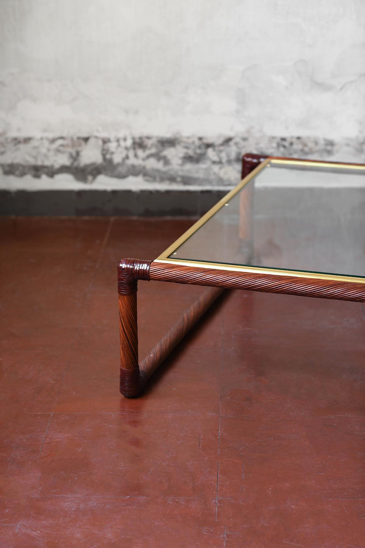 Late 20th Century Rattan coffee table with leather bindings, brass details and glass top, 1970s For Sale