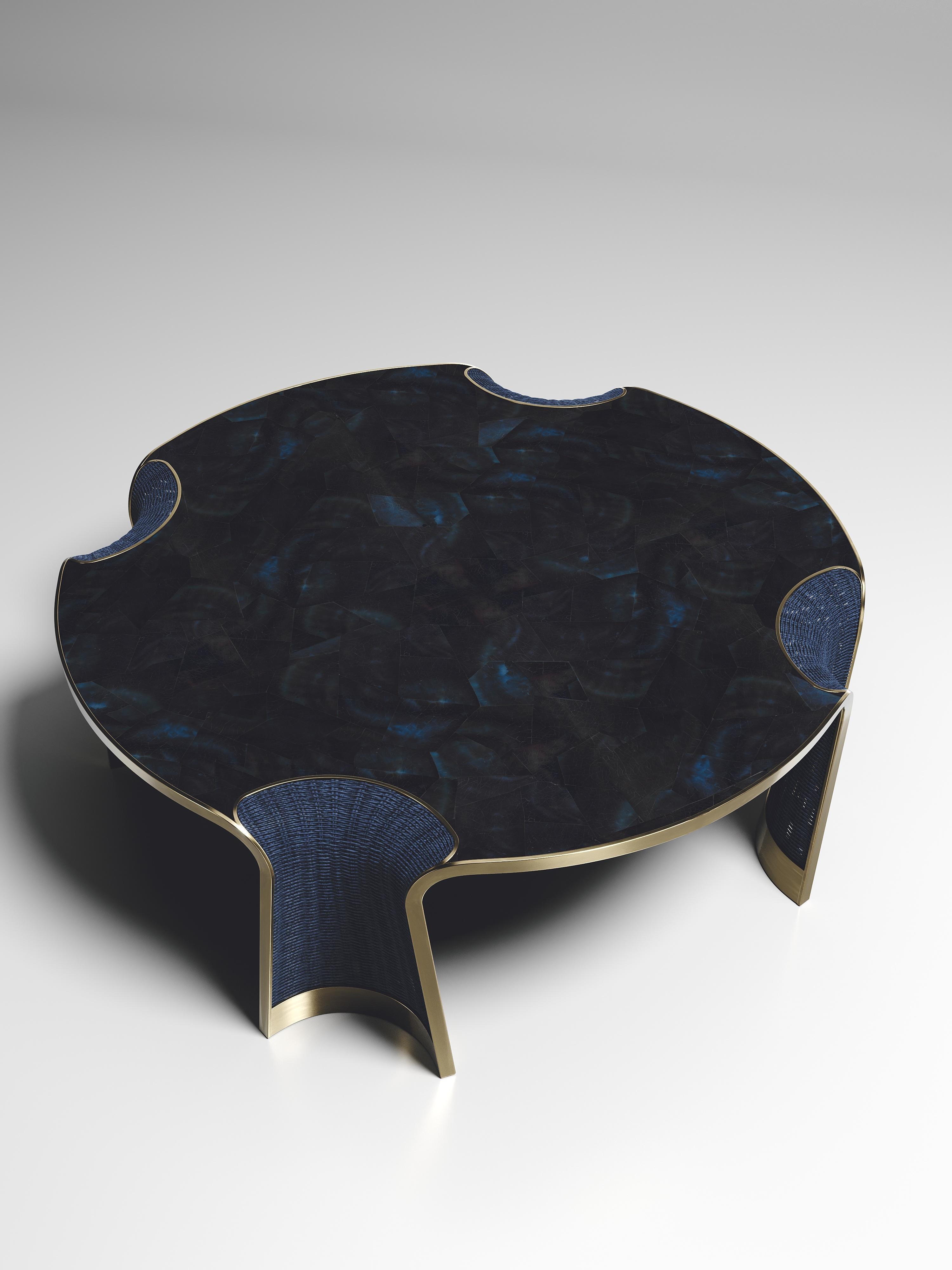 The Nymphea round coffee by R & Y Augousti is a part of their new Rattan capsule launch. The piece explores the brand's iconic DNA of bringing old world artisanal craft into a contemporary and utterly luxury feel. This table is done in a blue rattan