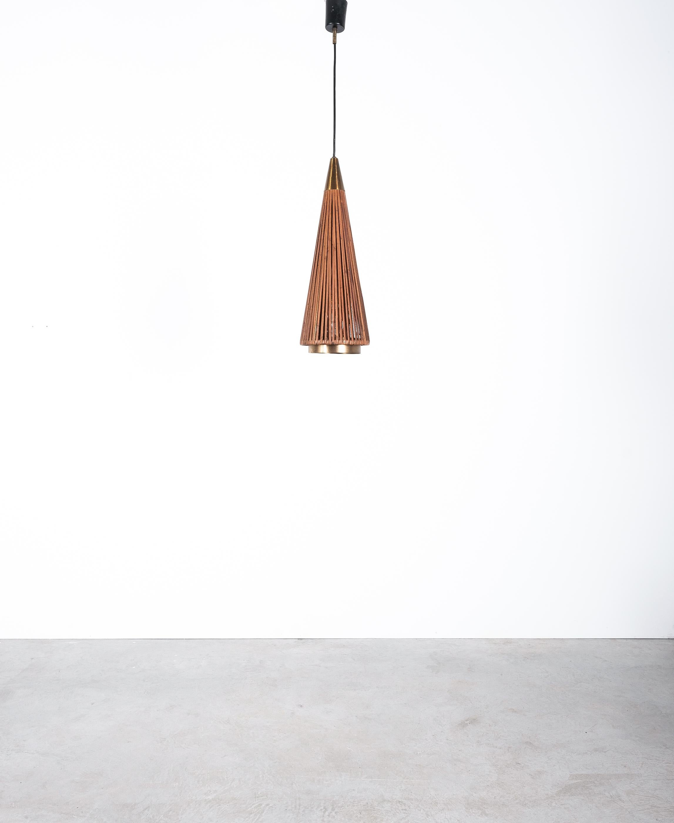 Rattan pendant lamp, Italy, midcentury.

Dimensions: 7.87 (diameter) x 20.1 (height lamp shape only) 59 (overall height)

Rare rattan shade pendant light, circa 1950, Italy, featuring a very long cone shaped rattan shade with a brass cone on top