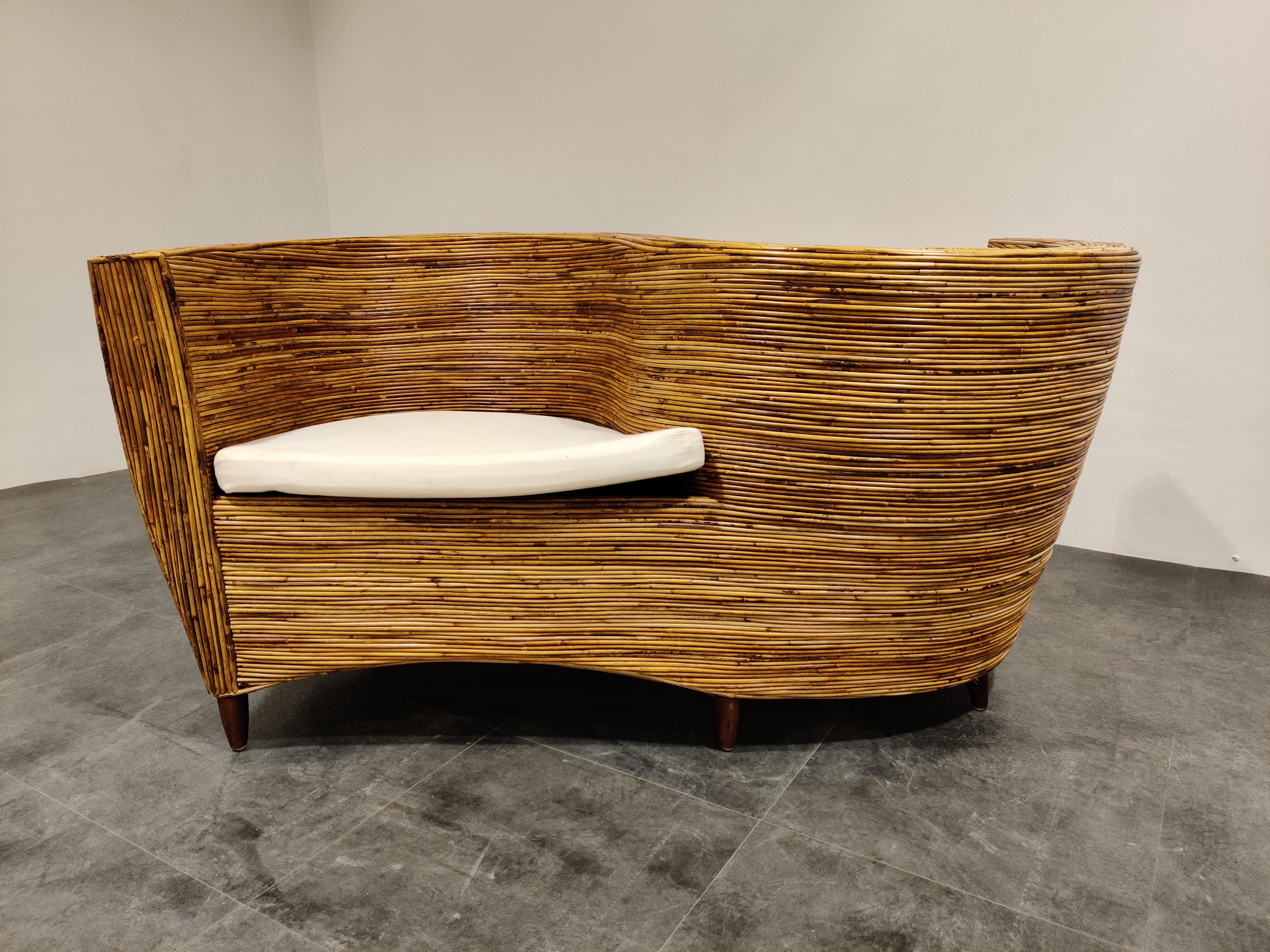 Amazing serpentine design rattan sofa/conversation chair by Vivai Del Sud

A lot of craftmanship went into making this chair and it looks fabulous. 

It looks timeless and combines with a lot of interiors. Great piece for in a patio as