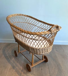 Rattan cradle on casters. French work. Circa 1950