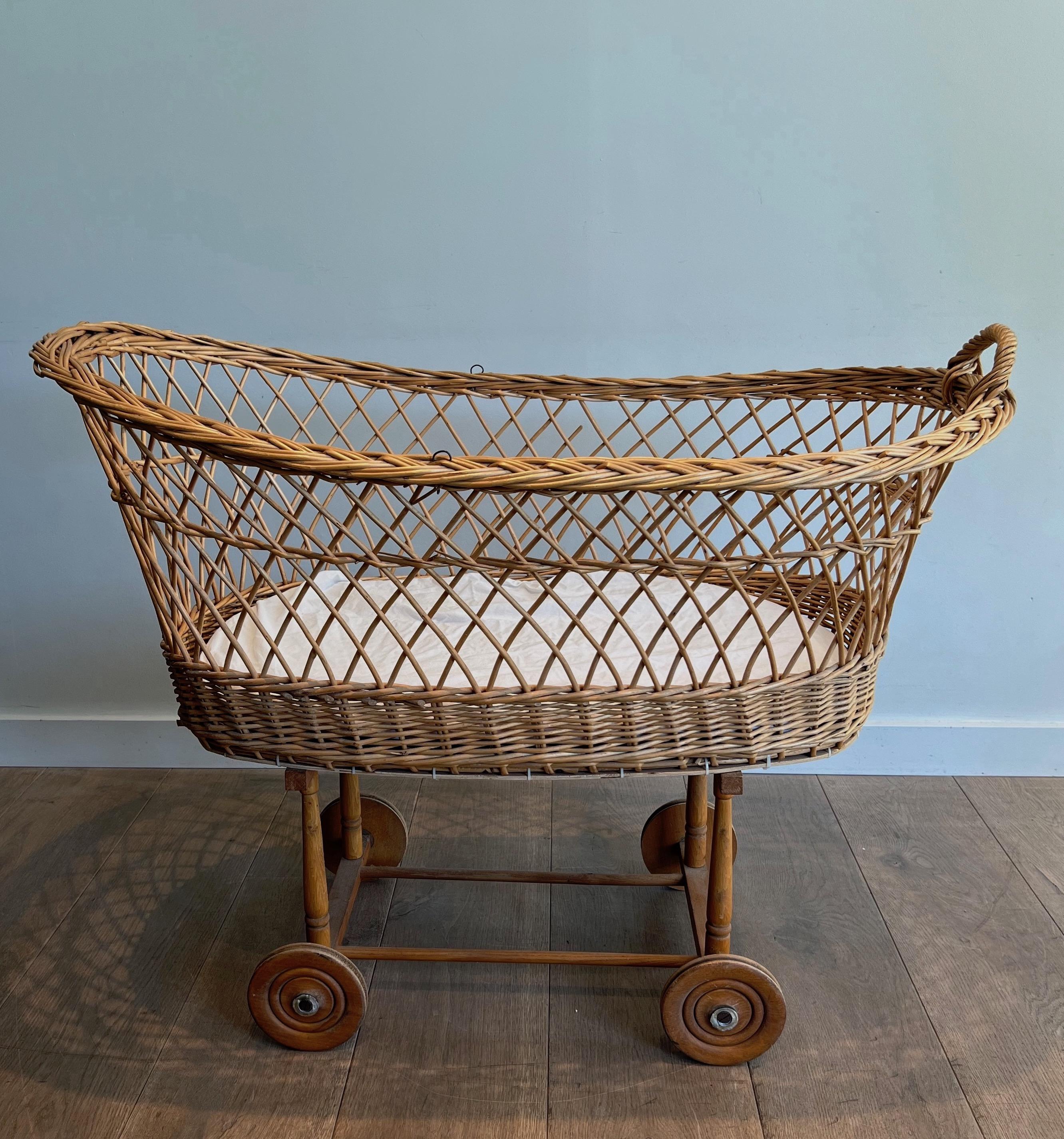 Mid-Century Modern Rattan cradle on casters. French work. Circa 1950 For Sale