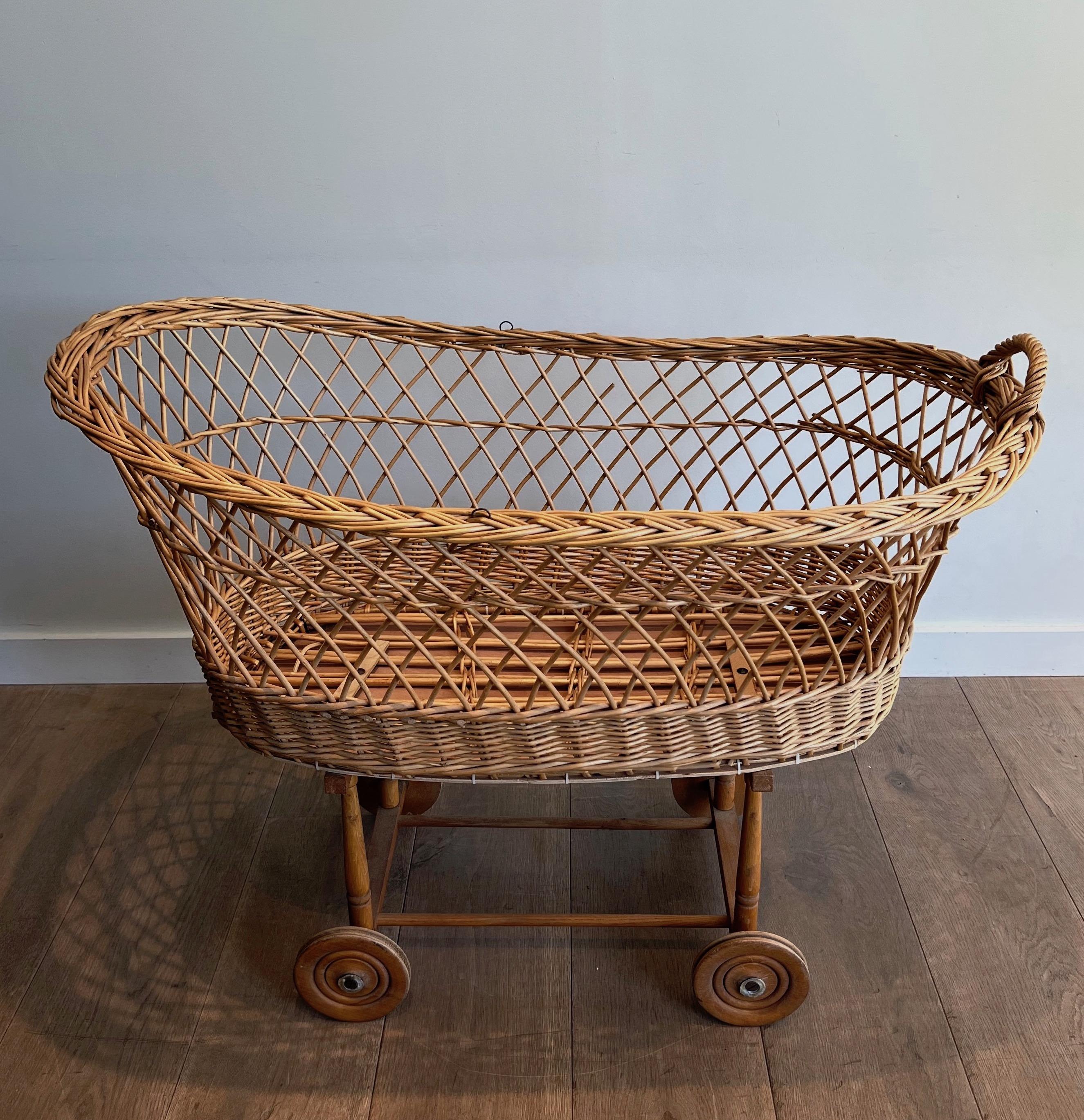 Mid-Century Modern Rattan cradle on casters. French work. Circa 1950 For Sale