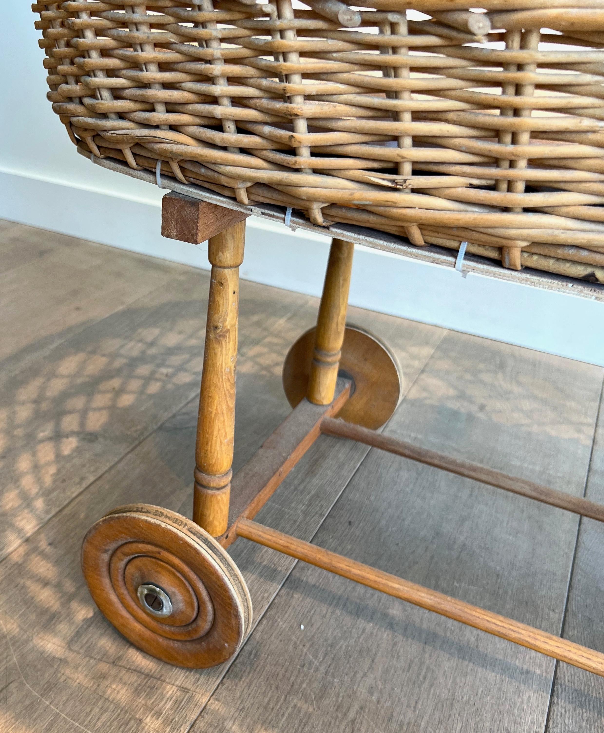 Mid-20th Century Rattan cradle on casters. French work. Circa 1950 For Sale