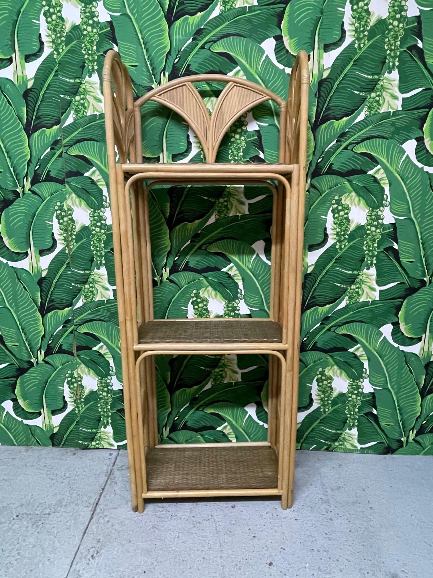 Rattan étagère in the style of Gabriella Crespi features palm leaf motif with pencil reed veneer and woven wicker wrapped shelves. Good condition with minor imperfections consistent with age.