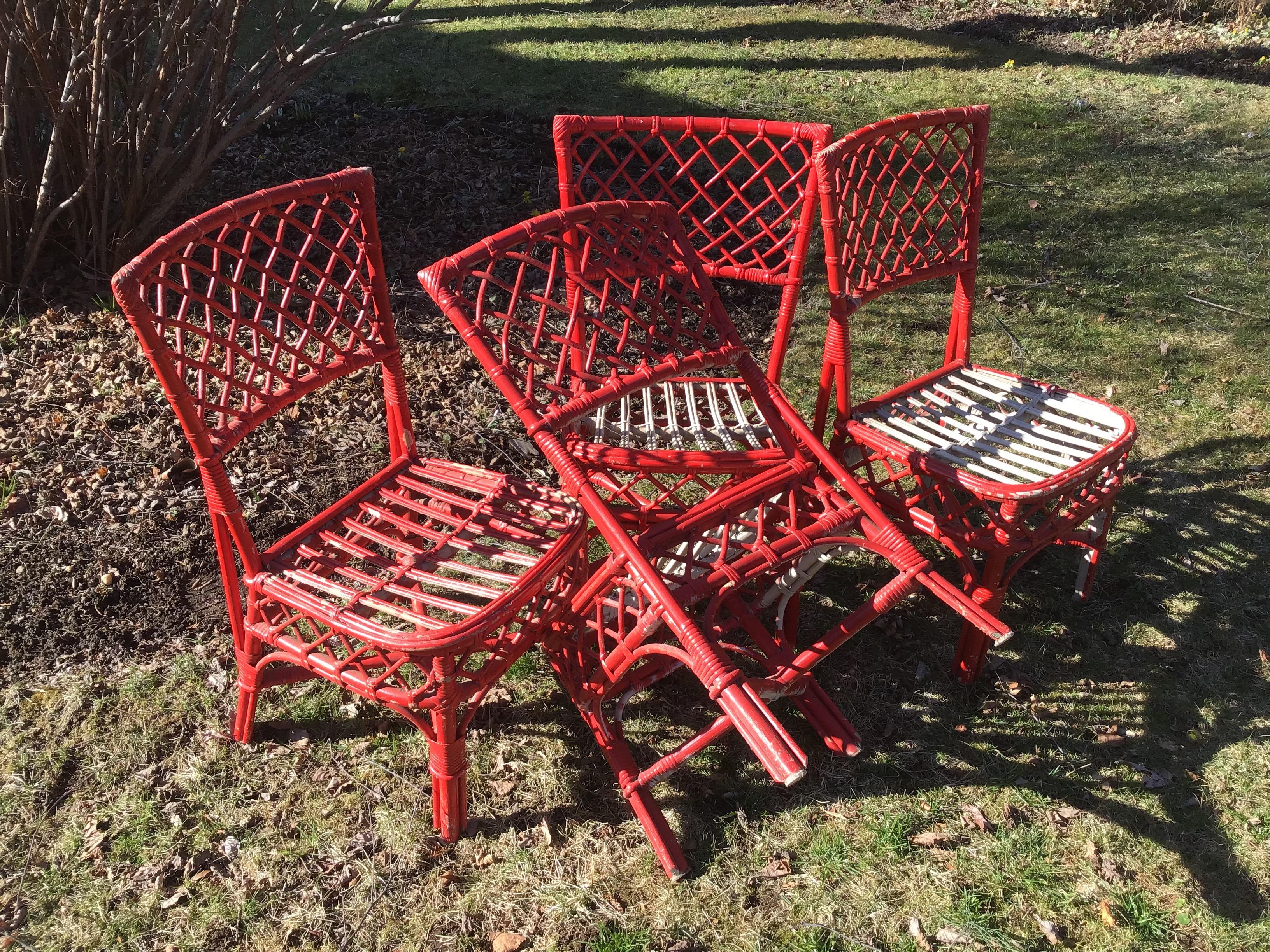 These rattan / cane / bamboo dining chairs are extremely sturdy. They look to be Mid Century, 1970s, side chairs in a set of 4.
Someone has painted them fire engine red for their Hampton's beach house, but can easily be repainted.
Chair: 34