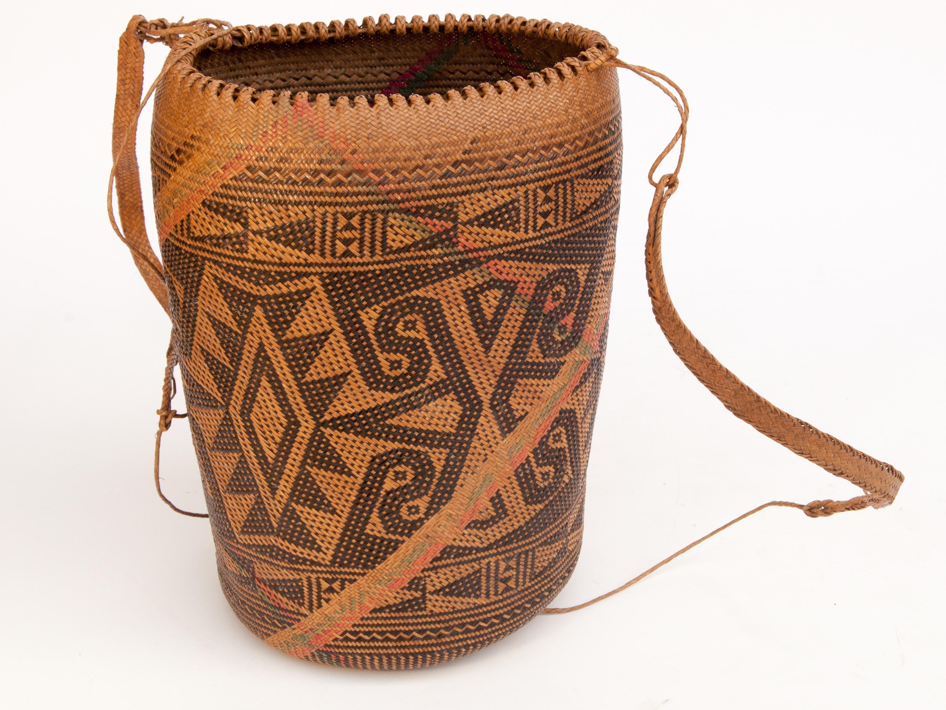 Rattan drawstring shoulder bag basket. Punan of Borneo, late 20th century.
This thoroughly utilitarian shoulder basket comes from the Punan of Borneo. Very cleanly woven of rattan with a geometric design, it is pliable and extremely durable. The