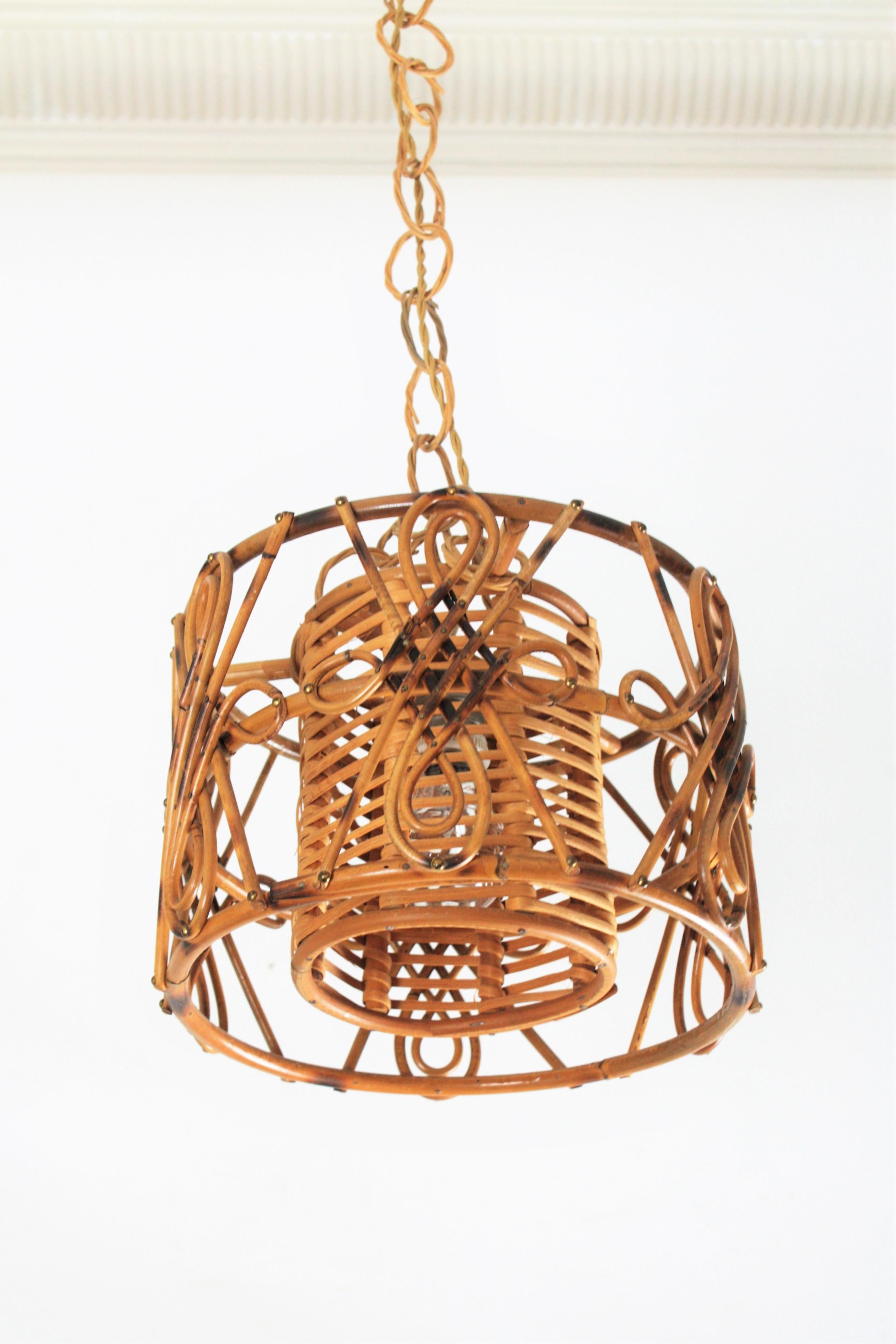 Handcrafted bamboo and rattan drum shaped chandelier with interior woven wicker / rattan shade. 
Manufactured at the Mid-Century Modern period with chinoiserie accents. France, 1950s.
The chain can be shortened to adjusted it to the desired height.