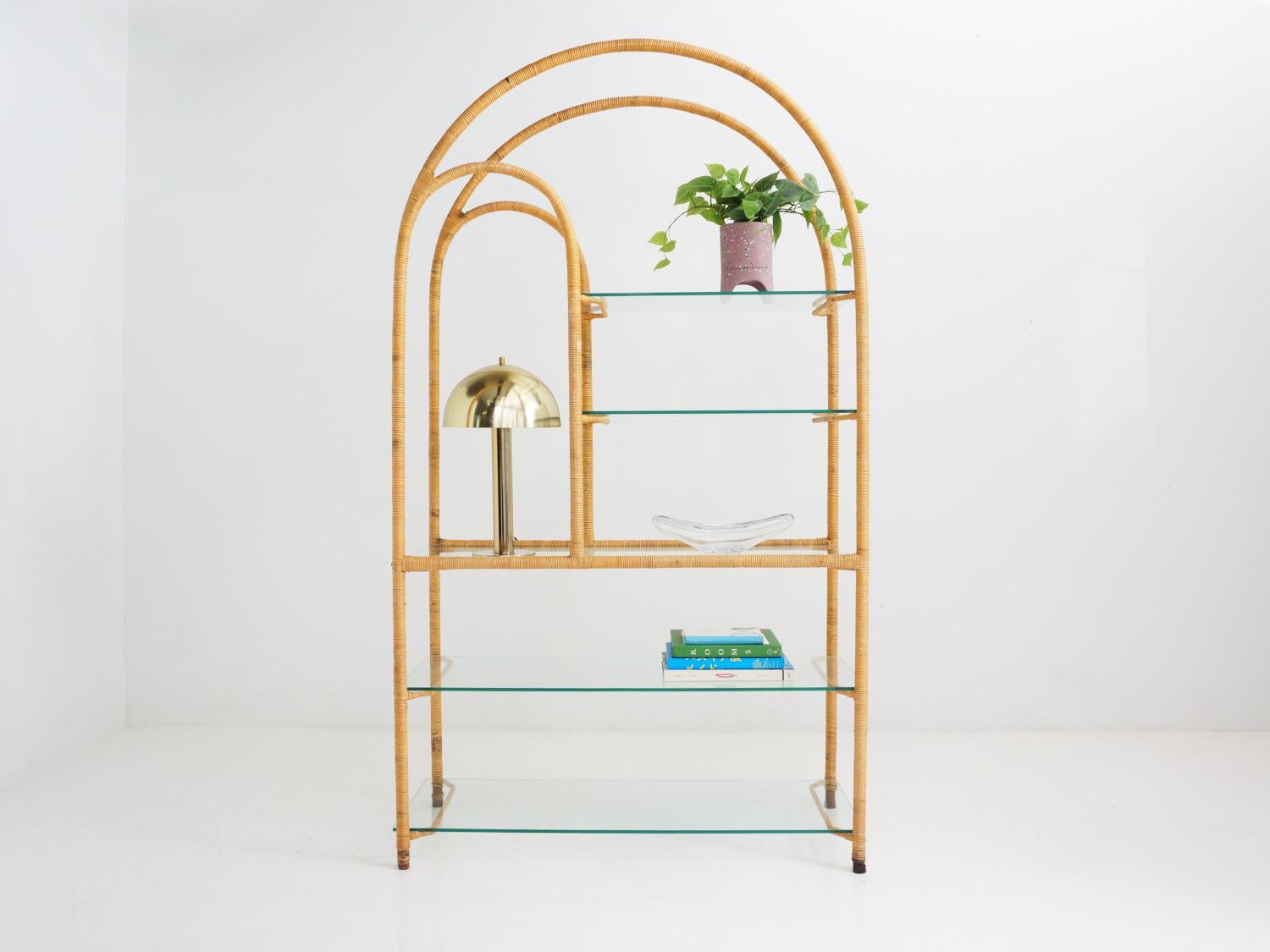 This arched étagère combines the warmth of rattan with an airy, open design, providing both functionality and charm to display your cherished items in style.

- 75.5