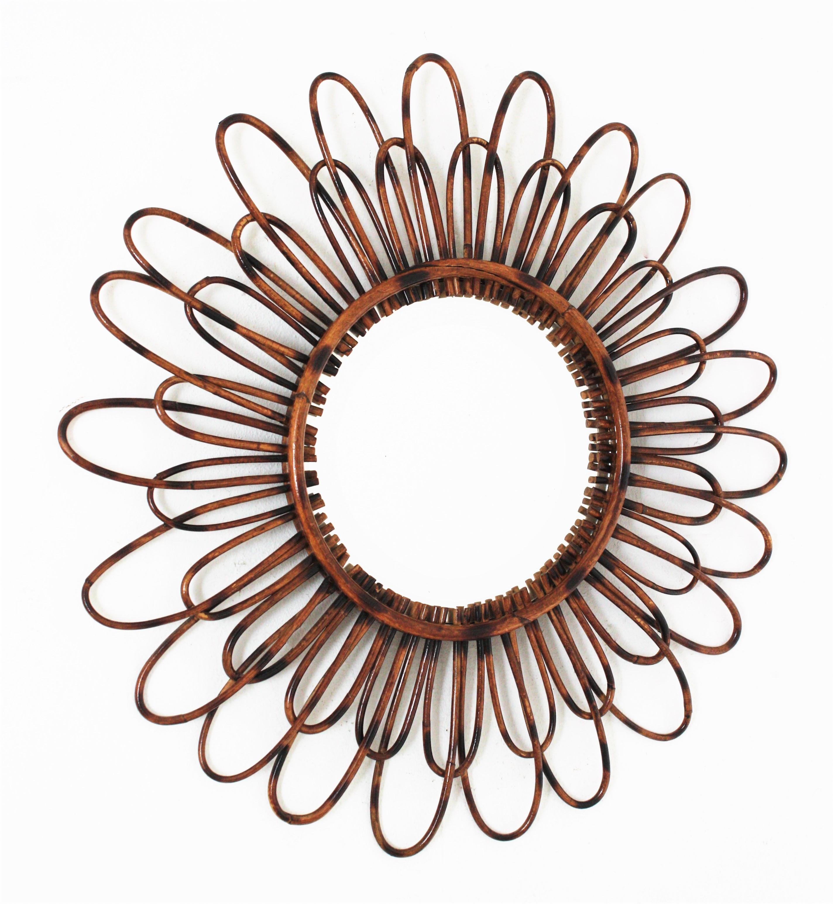 Handcrafted rattan double layered flower shaped mirror / sunburst mirror, Spain, 1950s
A lovely Mediterranean style handcrafted rattan flower shaped mirror with two layers of petals in two sizes and pyrography accents.
Beautiful to place alone and