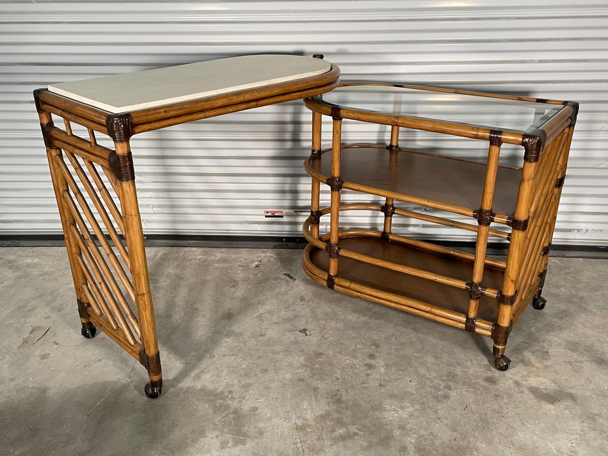 Rattan bar cart by Lexington Furniture features folding design and antique brass casters. Beveled glass top on lower section, upper section has a sealed Cordova stone surface. Good condition with minor imperfections consistent with age, see photos