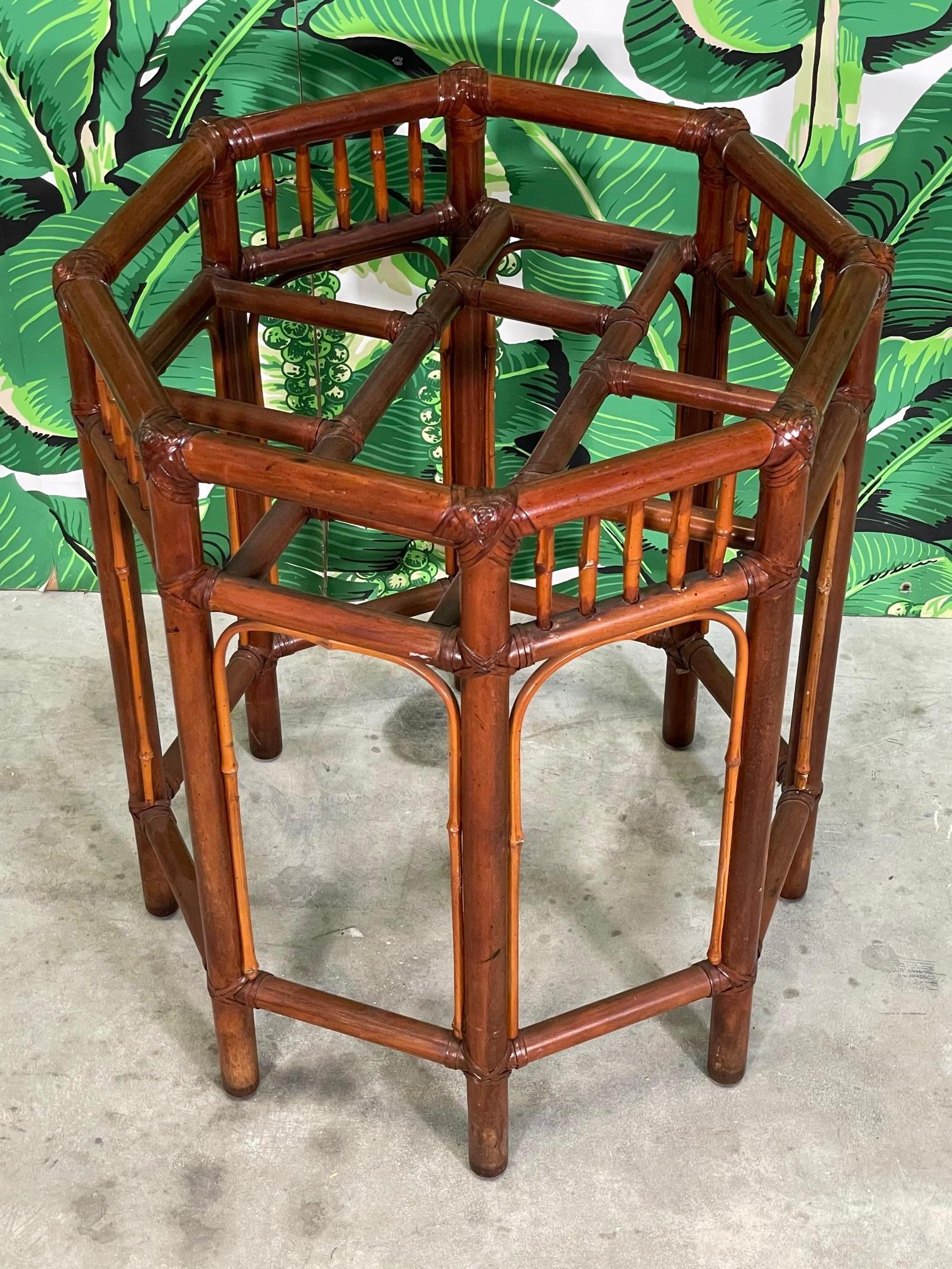 Vintage rattan dining table base features decorative fretwork and a rich, deep brown finish. Good condition with minor imperfections consistent with age (see photos).

 
