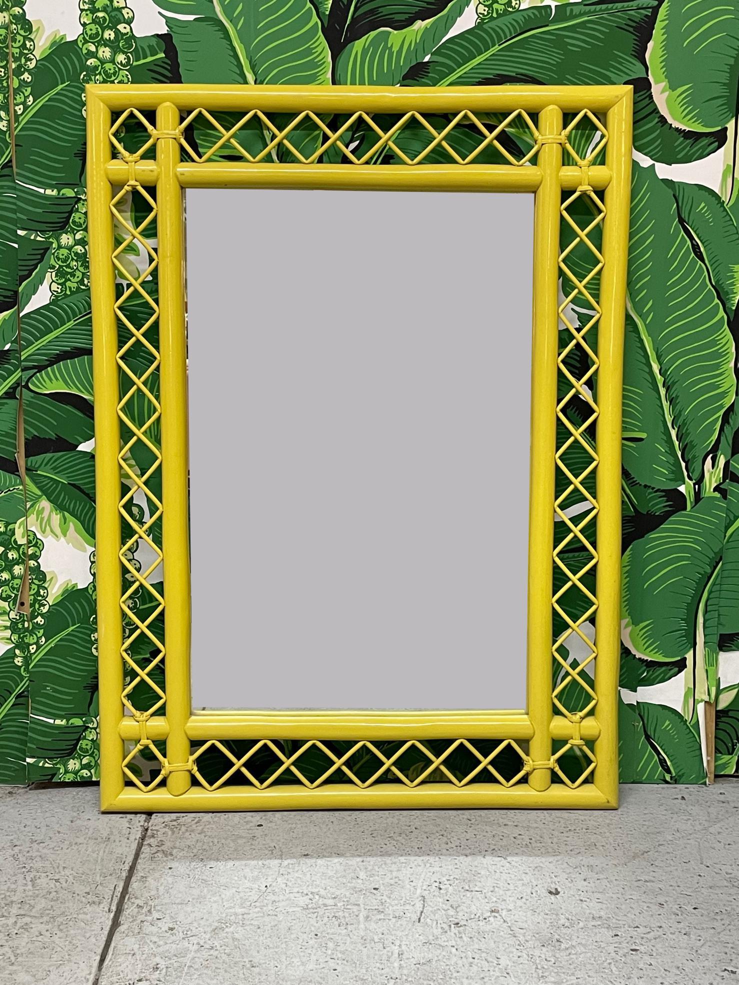 Vintage rattan wall mirror features intricate fretwork and a bright, cheery yellow lacquered finish. Good condition with only very minor imperfections consistent with age.

 
