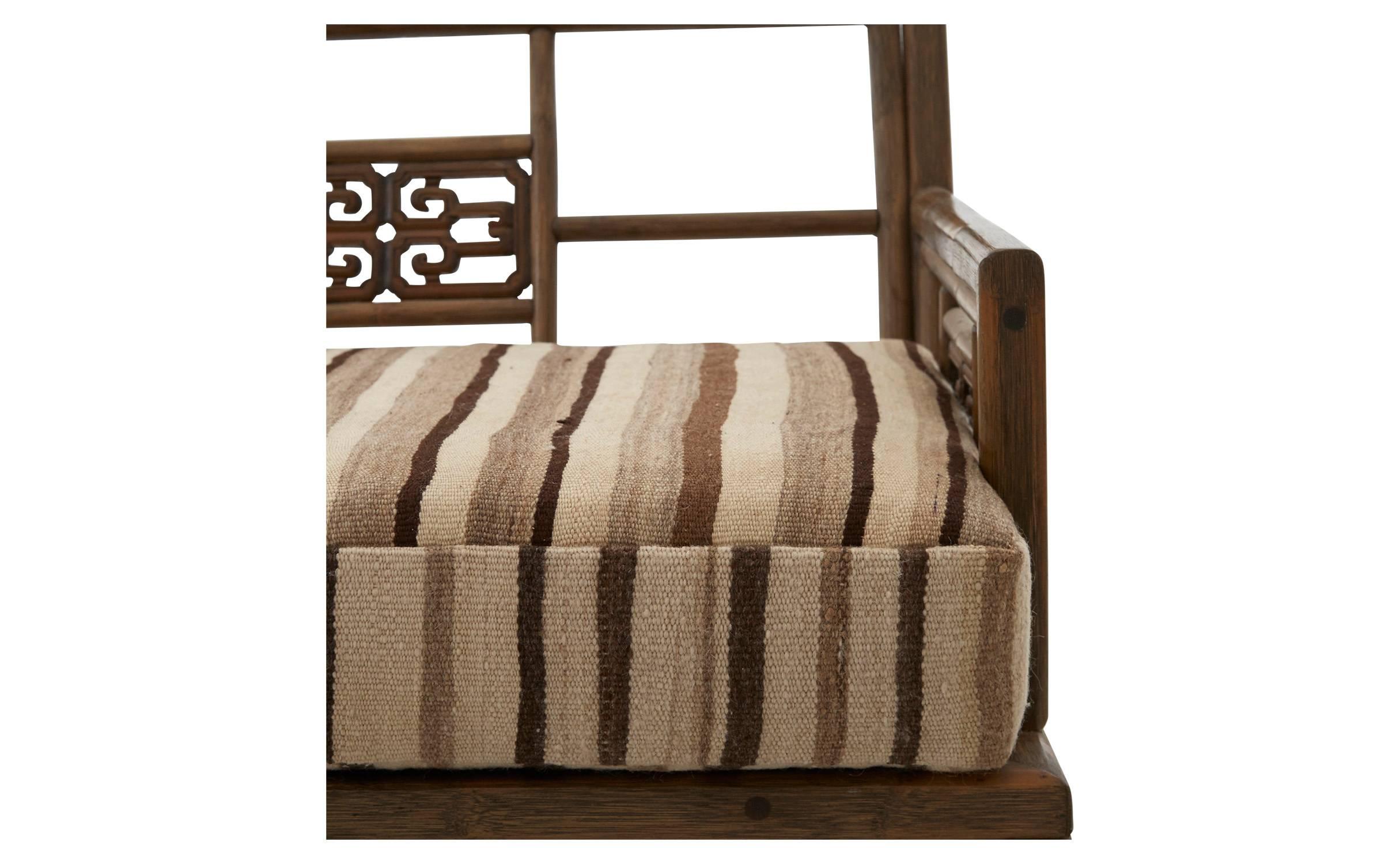 Found in America, our Vintage Rattan Greek Key Sofa was made in the 20th century. Crafted from rattan wood, this simple, clean-lined frame is decorated with carved details featuring the iconic Greek key motif. Its three plush seat cushions have been