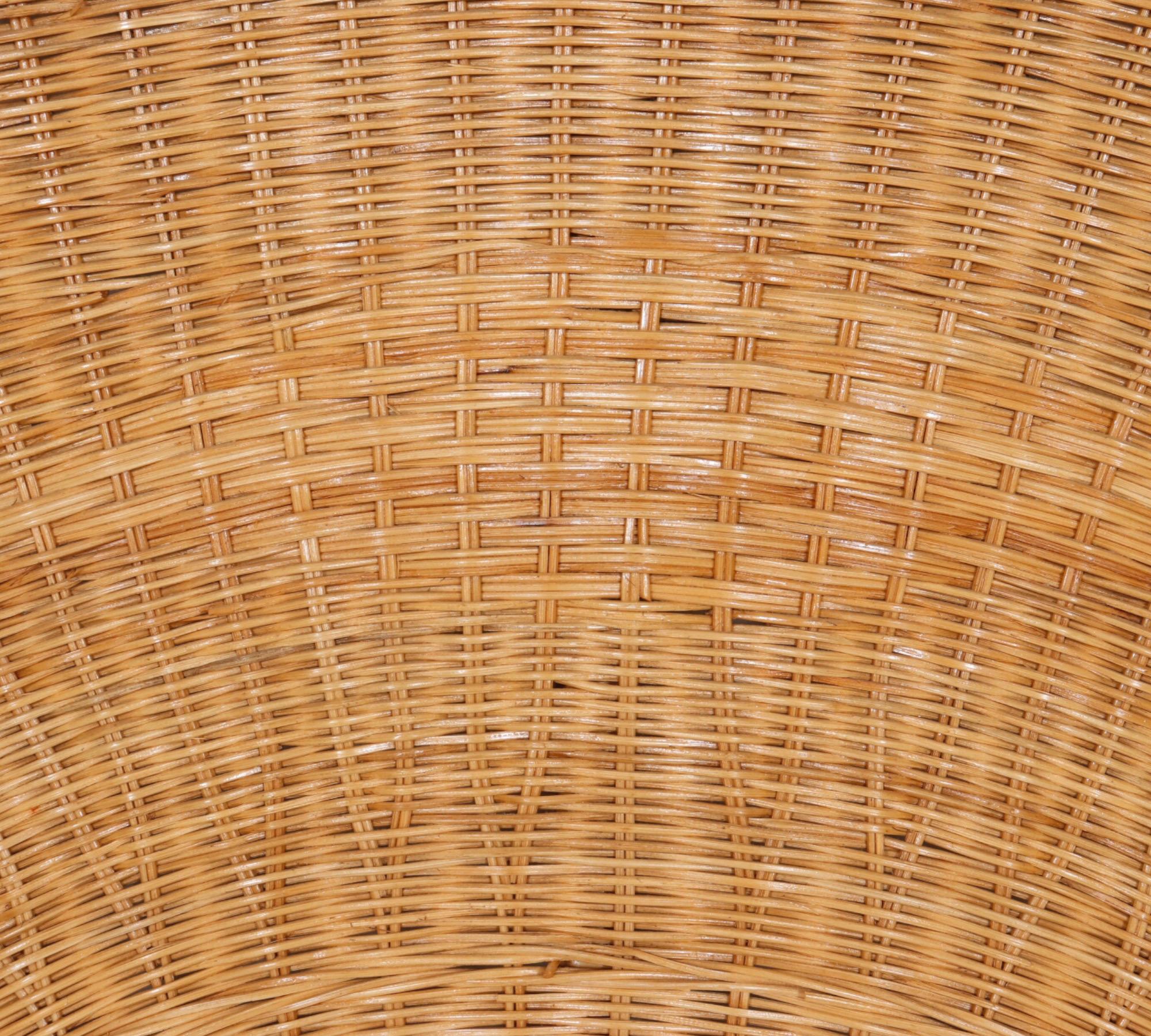 A half-moon full size headboard made of wicker woven rattan. Decorated in the middle with a woven diamond and trimmed with braided rattan.
