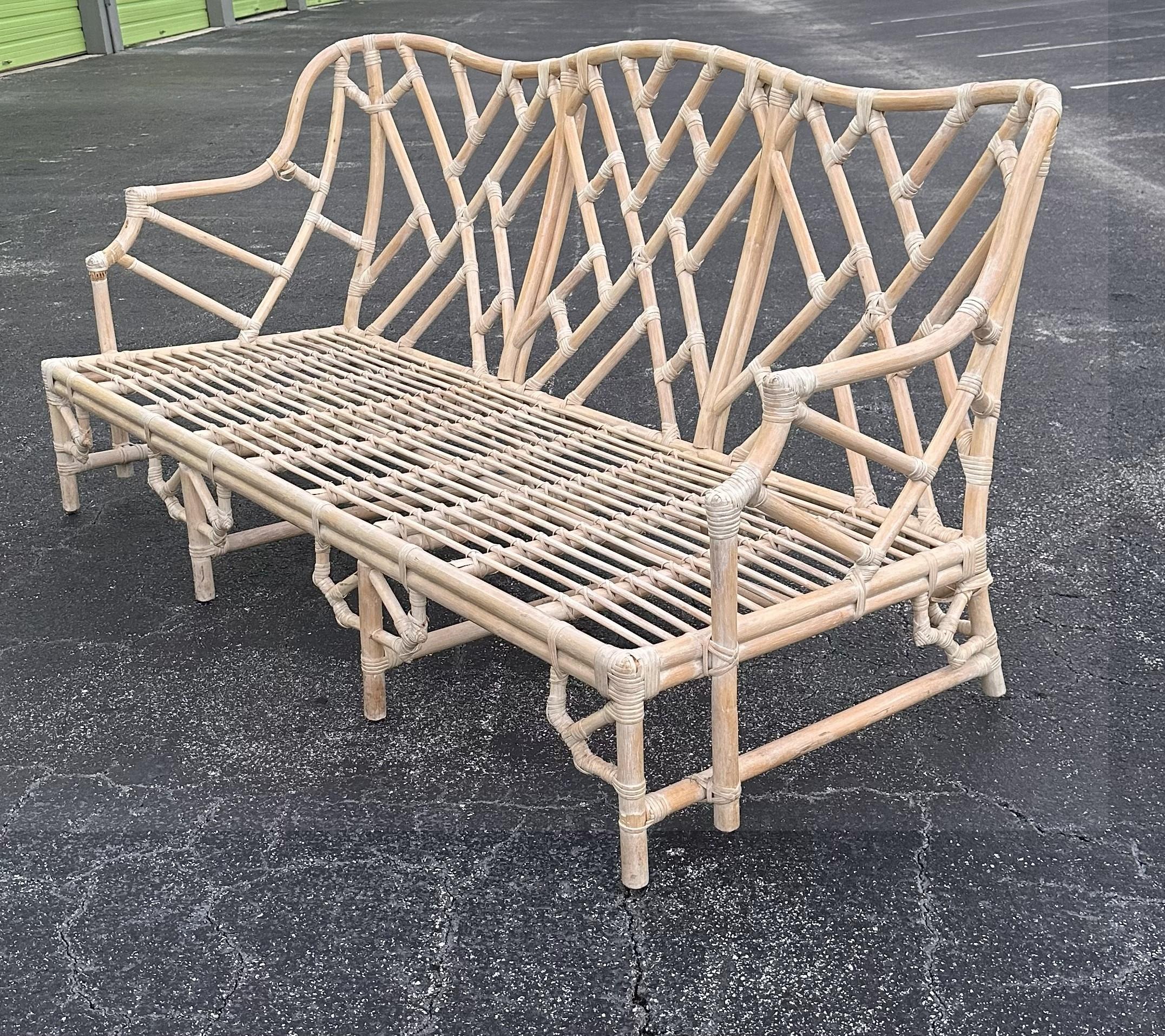 The product is a vintage Bielecky Brothers rattan fretwork sofa in a beige color, with a Chinese Chippendale Fretwork Hollywood Regency style. It has a height of 36 inches, a length of 72 inches, and a width of 34 inches. This coastal Chippendale