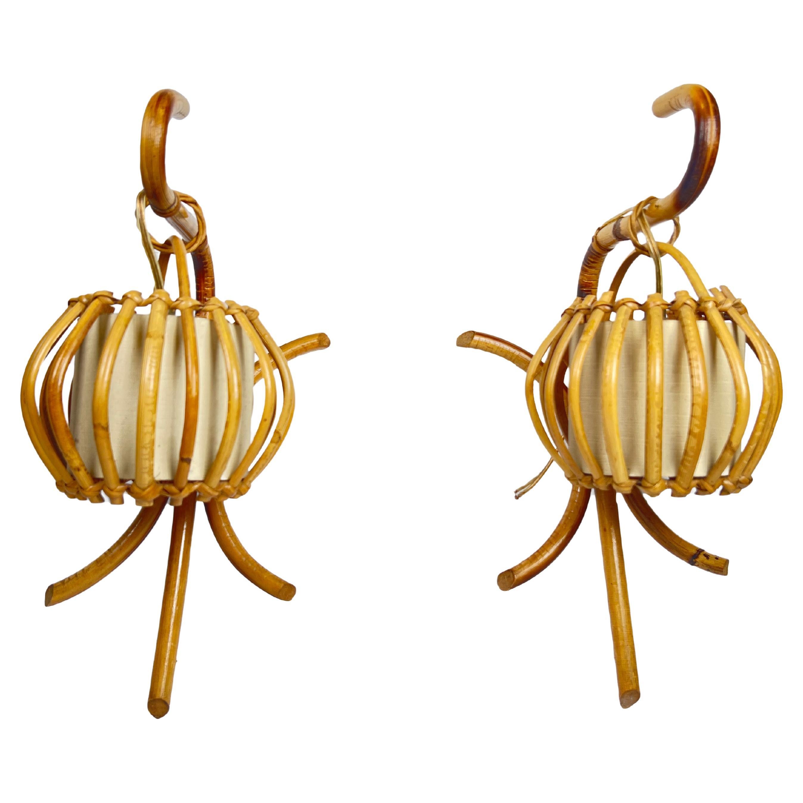 Rattan “Lantern” Sconces by Louis Sognot, circa 1960s 

Offered for sale is a circa 1960s pair of French rattan sconces by Louis Sognot (Paris, France, 1892-1970). They feature sculptural rattan ascending arms that hold delicate bamboo and rattan