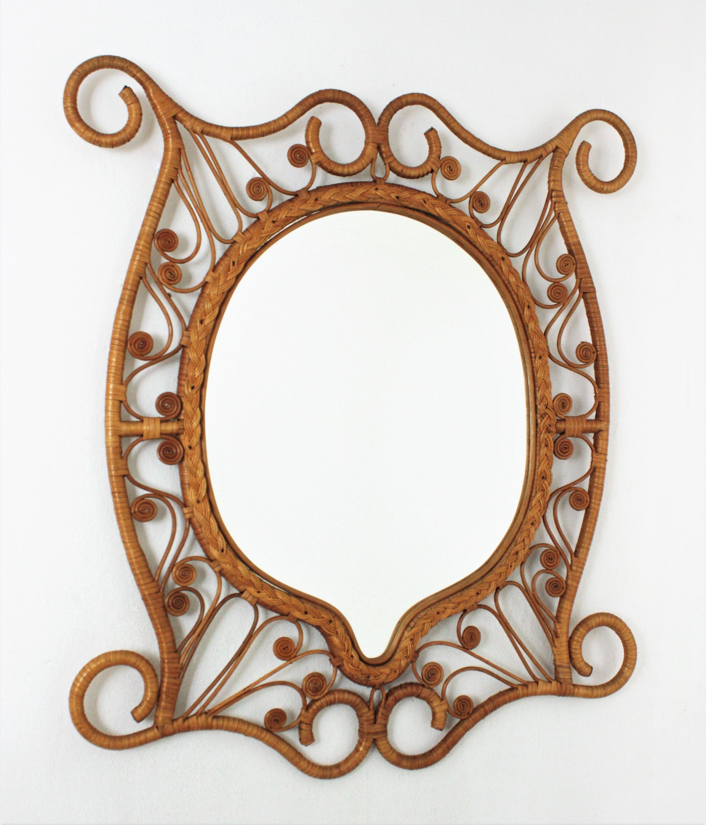 One of a kind handcrafted rattan mirror with scroll endings and Filigree peacok frame. Spain, 1960s.
This mirror features a beautiful artistic filigree peacock frame entirely handcrafted in wicker and rattan, with decorations thorough. It has all