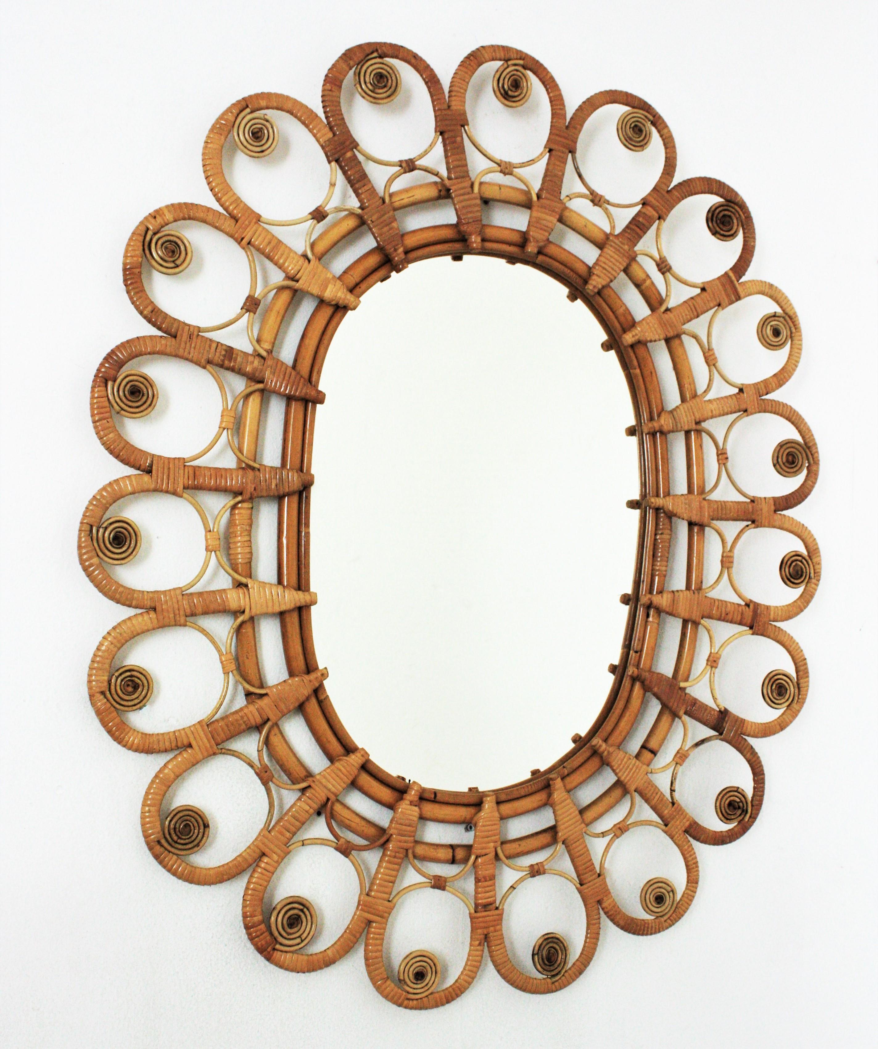 Large oval shaped handcrafted wicker and rattan mirror with a beautiful artistic filigree peacock frame, Spain, 1960s.
This mirror has all the taste of the Mediterranean and bohemian style and reminiscences of the design of the Peacock chairs.
All