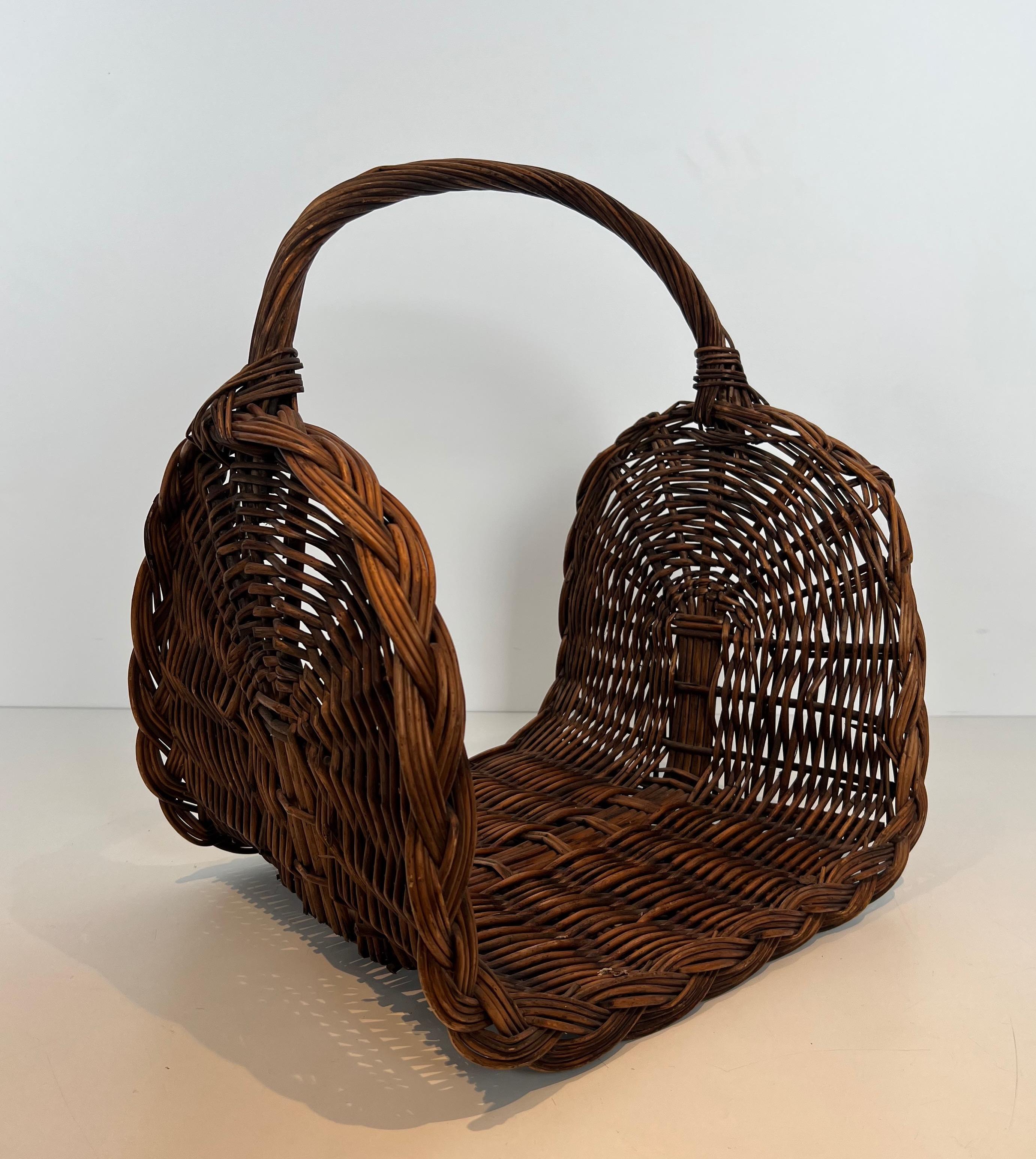 This logs holder. is made of rattan. This is a French work. Circa 1970