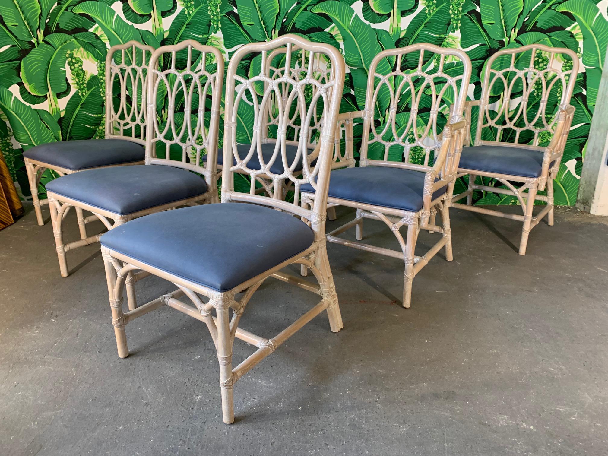 Set of 6 rattan dining chairs by Lexington feature loop back styling and solid construction. Very good condition with minimal imperfections other than cushions which are slightly stained.