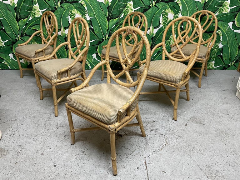 Set of six rattan loop back chairs in the style of McGuire. Splayed legs and a sinuous loop slat back. Cream finish with intentional crazing throughout for a distinct look. Good condition with minor imperfections consistent with age (see