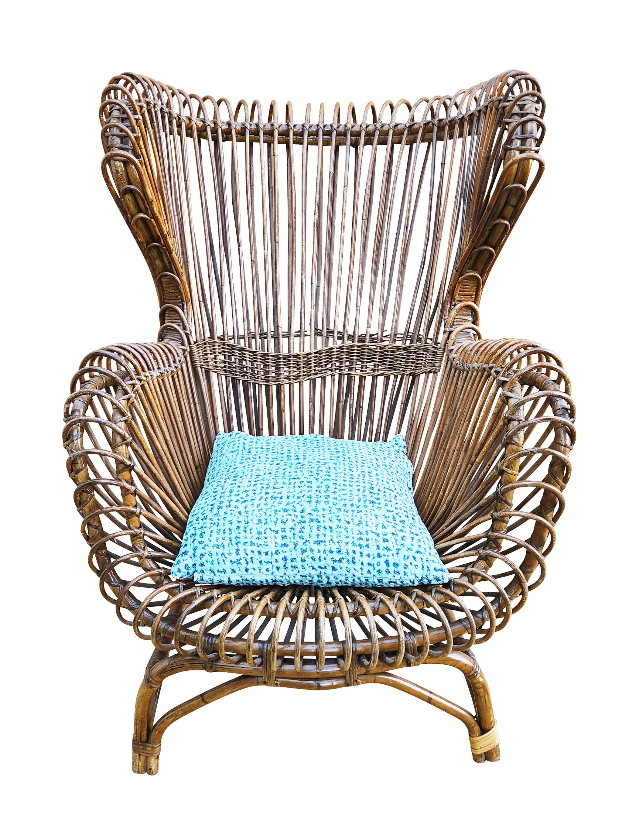 Sculptural and comfortable Italian Mid-Century lounge chair made in rattan by Bonacina. The design is attributed to either Franco Albini or Tito Agnoli who worked extensively with this material.

Condition: Good vintage condition, minor wear