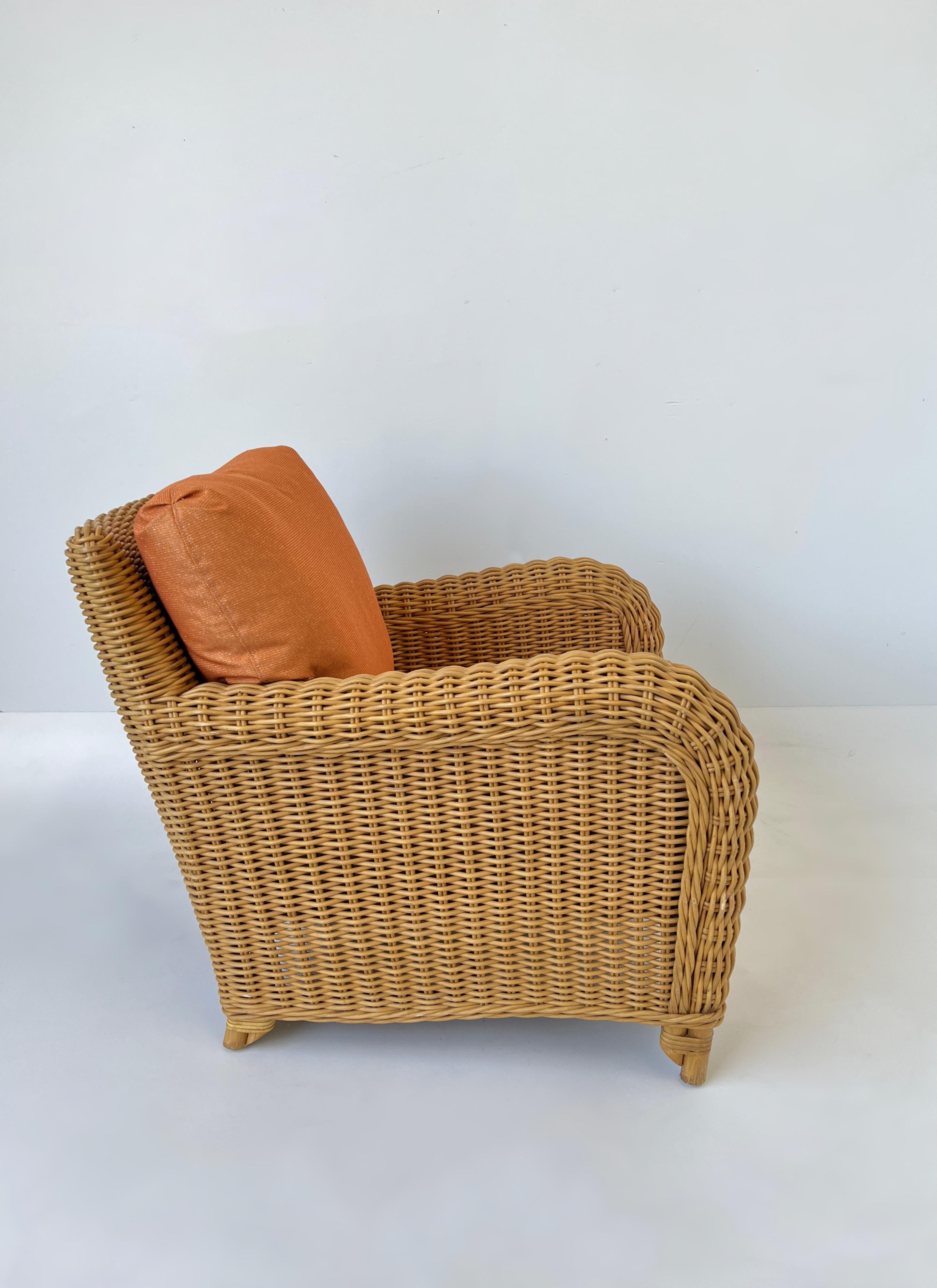1980’s Rattan and orange lounge chair by John Hutton for Donghia. 
The frame is in original condition, it shows minor wear consistent with age. 
The cushion are newly recovered in a orange with gold thread and are down fill. 
Measurements: 31” Wide,