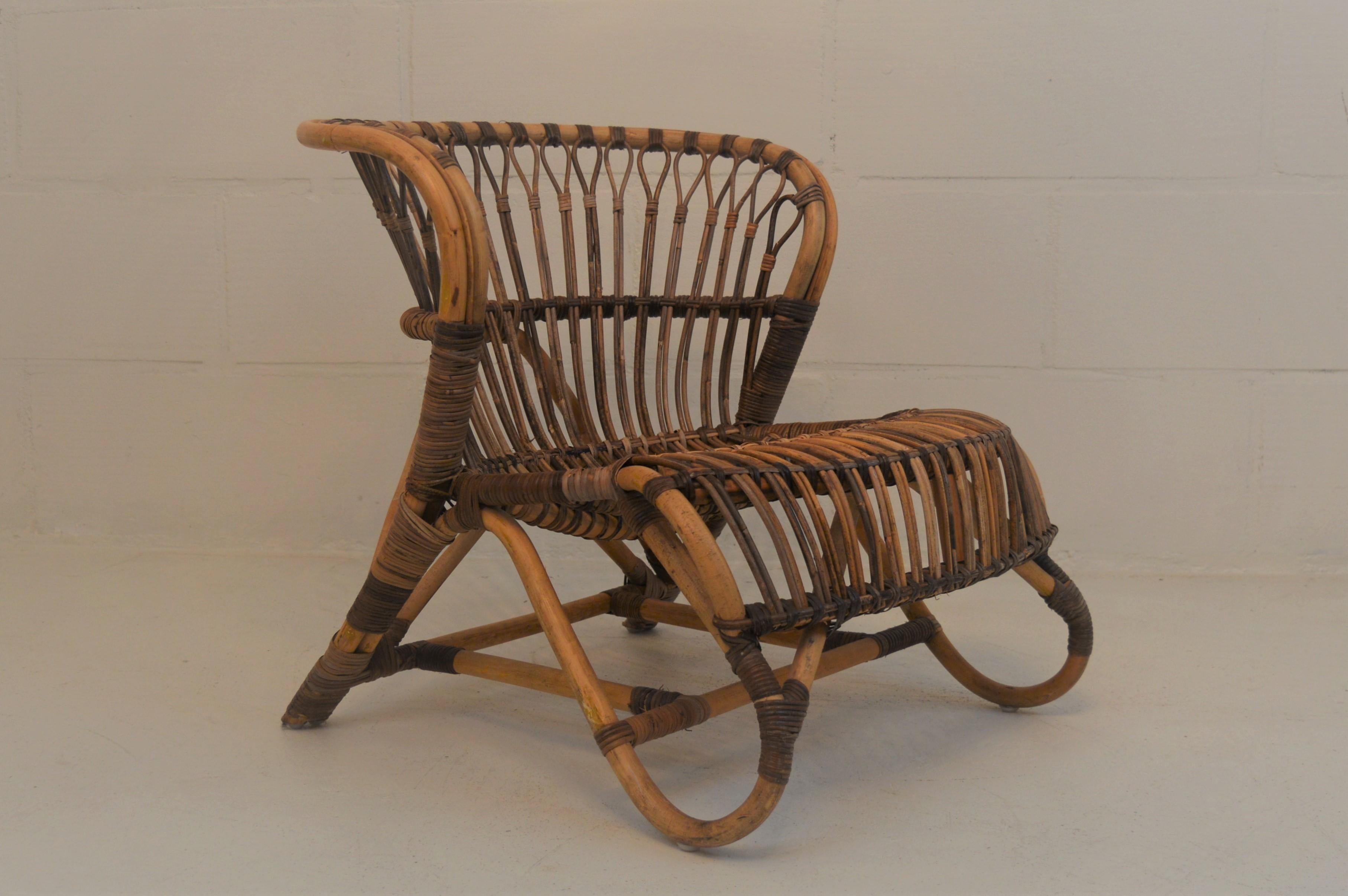 Unusual and early rattan lounge chair in the manner of Viggo Boesen, in a reasonable good condition in spite of his age.