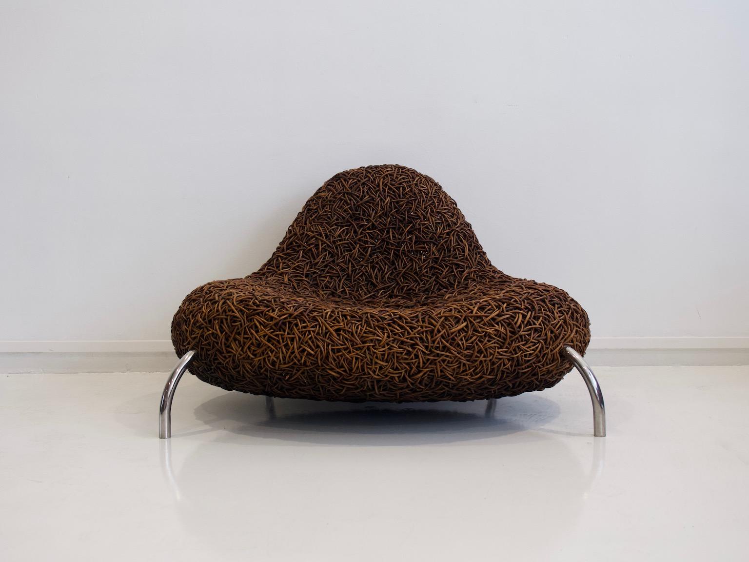 Lounge chair made of wicker with chromed metal feet by Udom Udomsrianan of Planet, 2001. The chair was an award winner at the Milan Furniture Fair in 2003. Comfortable to sit on, a statement piece for your home.