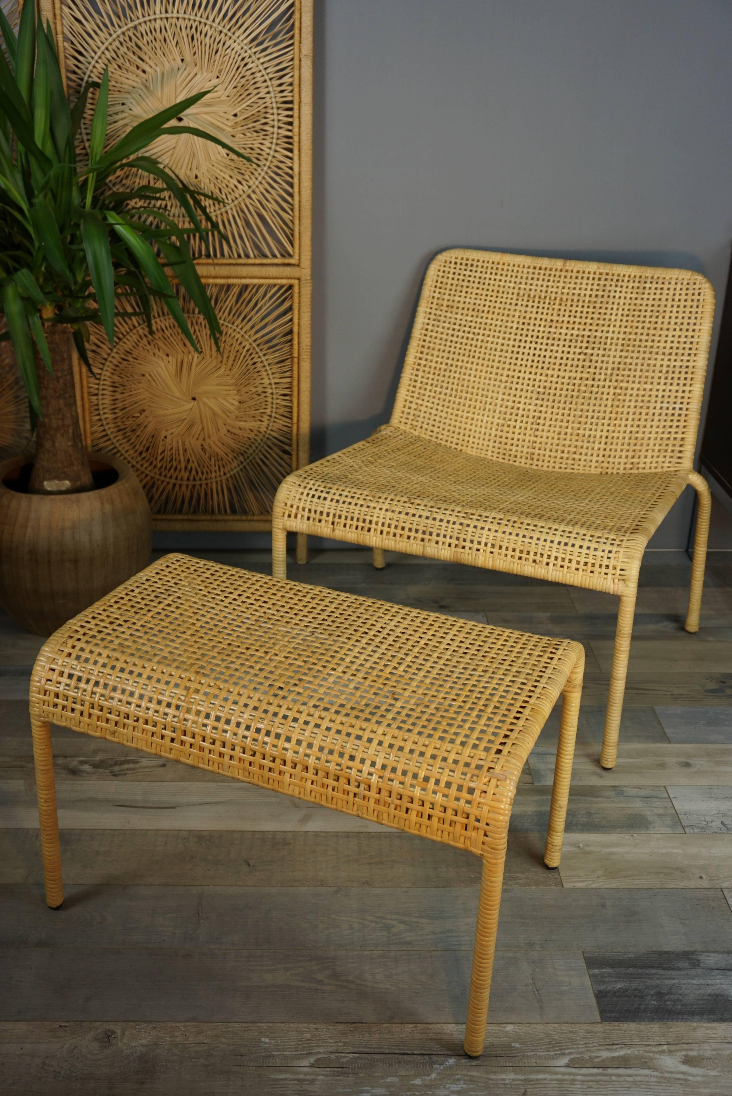 Vintage look and resolutely contemporary, this rattan lounge set is compose of an armchair with its ottoman (which can used as a matching table). Wonderful, poetic and comes from a French house specializing in the manufacture of rattan and has been